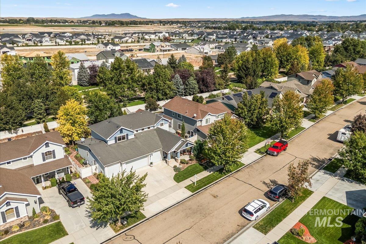 Aerial perspective of suburban area featuring a mountain backdrop