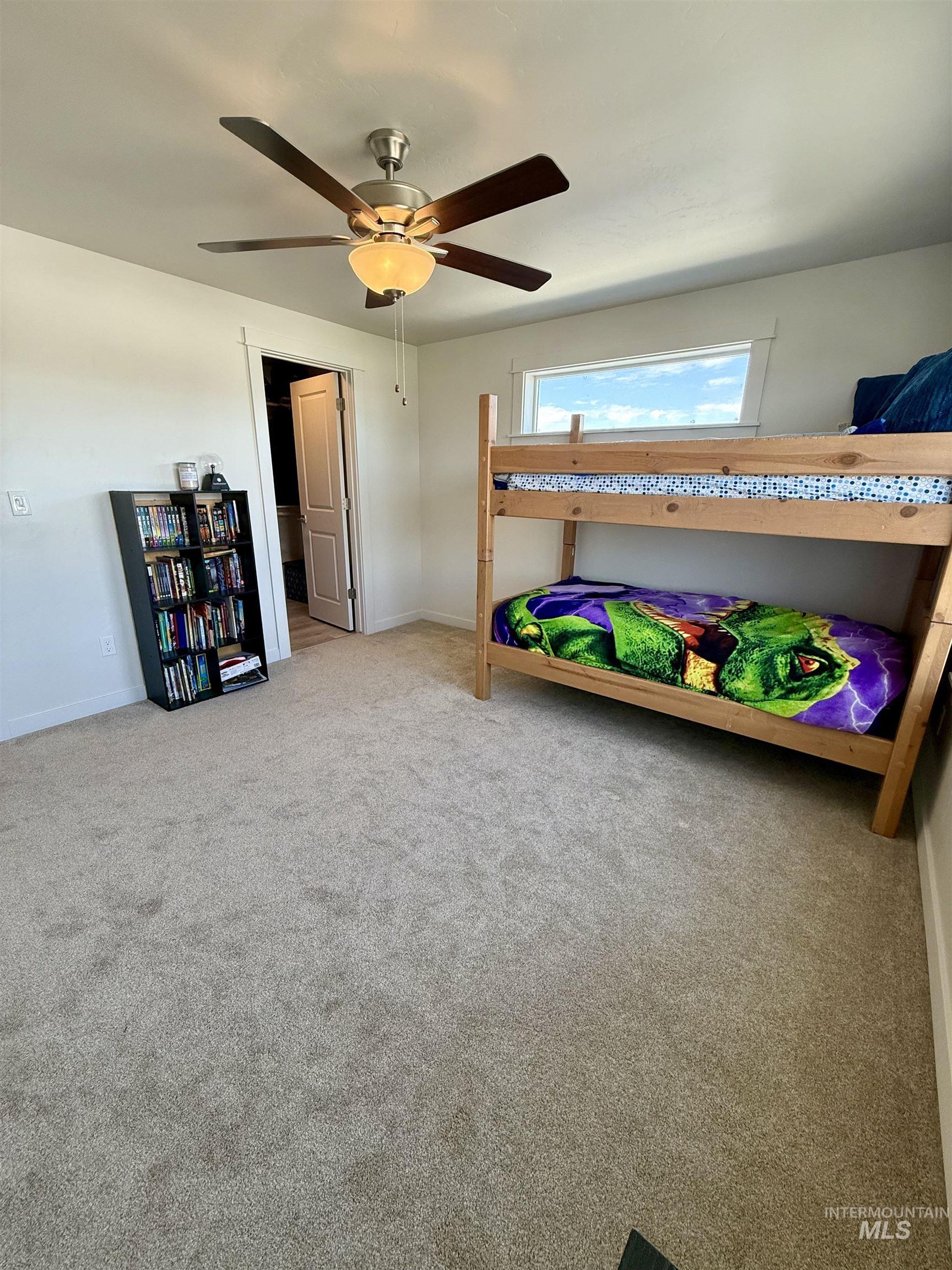 Bedroom with carpet flooring and a ceiling fan