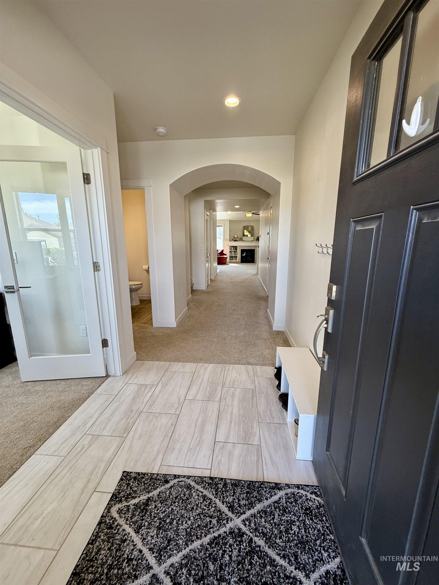 Hall featuring recessed lighting and arched walkways