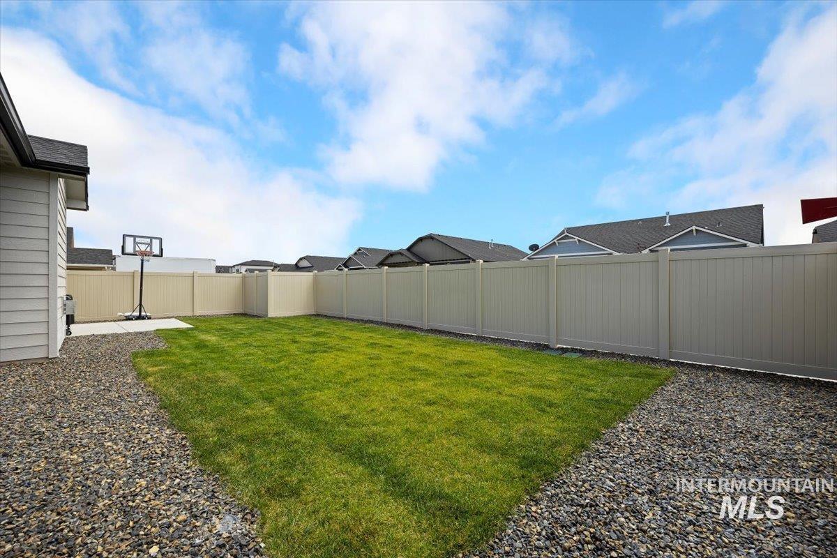 Fenced backyard with a residential view