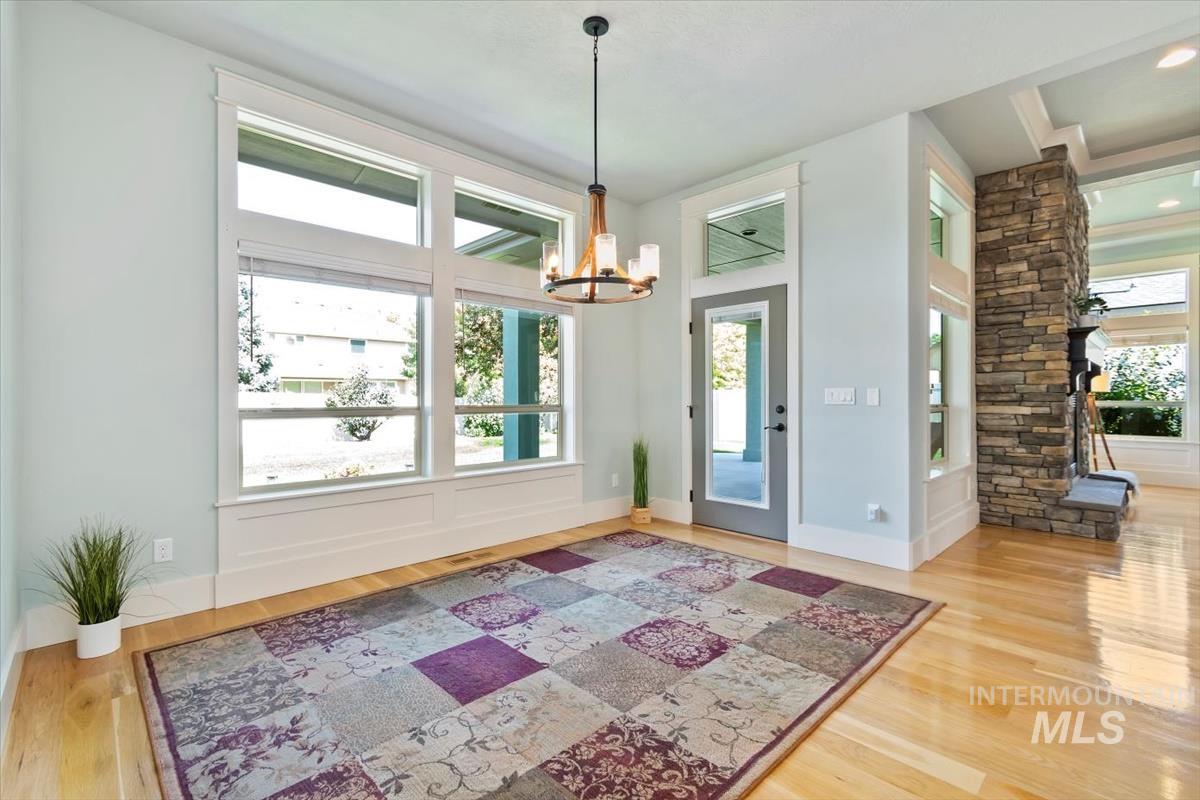 Foyer entrance with light wood-type flooring and a chandelier