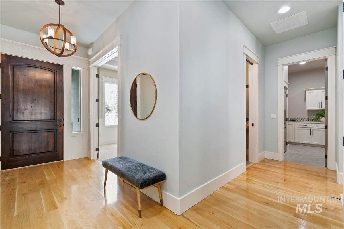 Entrance foyer with light wood-style flooring, a chandelier, and recessed lighting