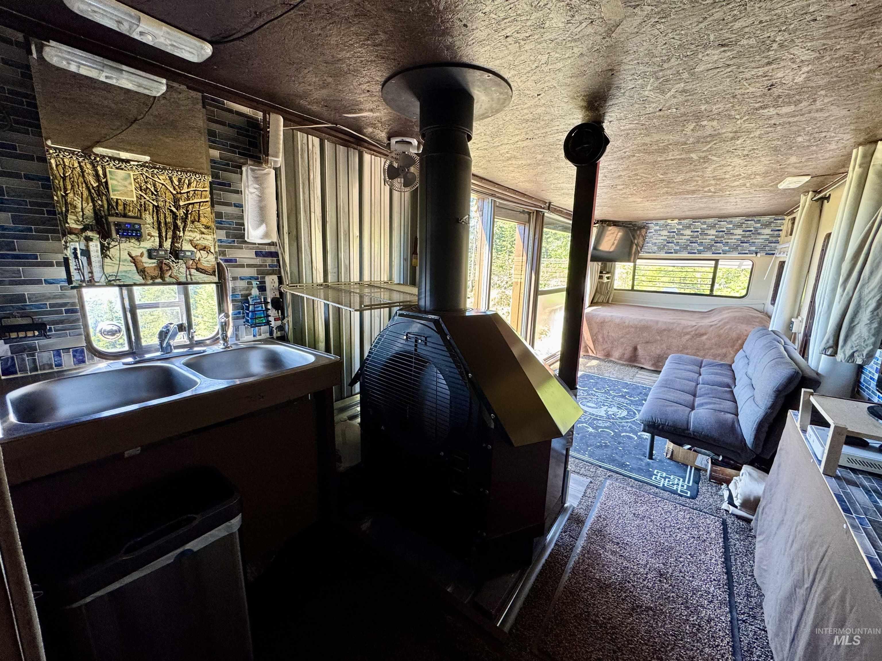 Misc room with a sink and a wood stove