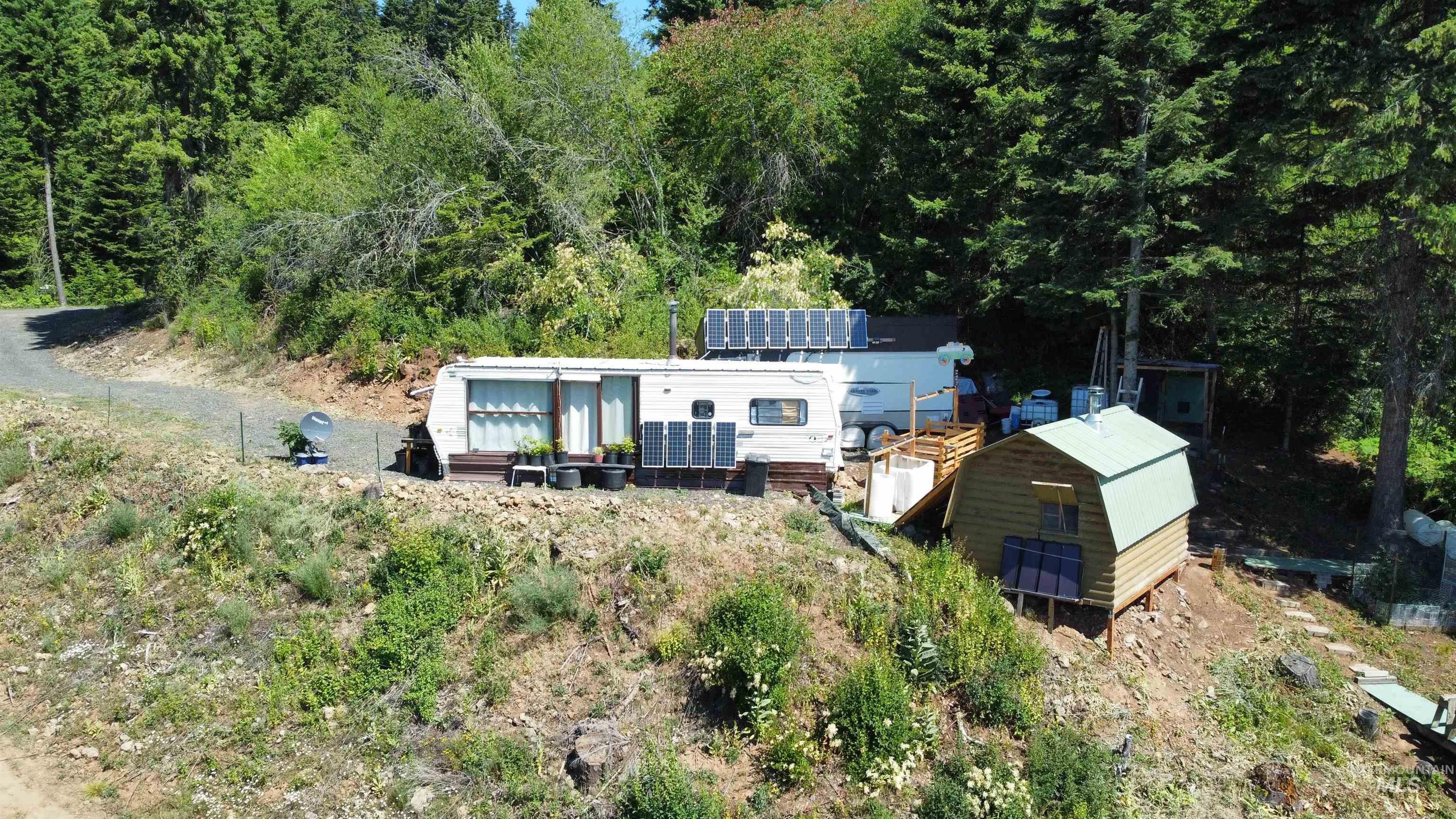 View of subject property featuring a forest