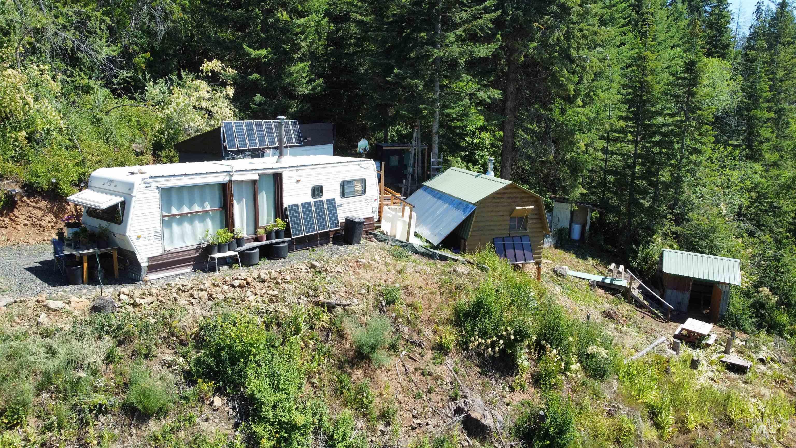 View of subject property with a forest