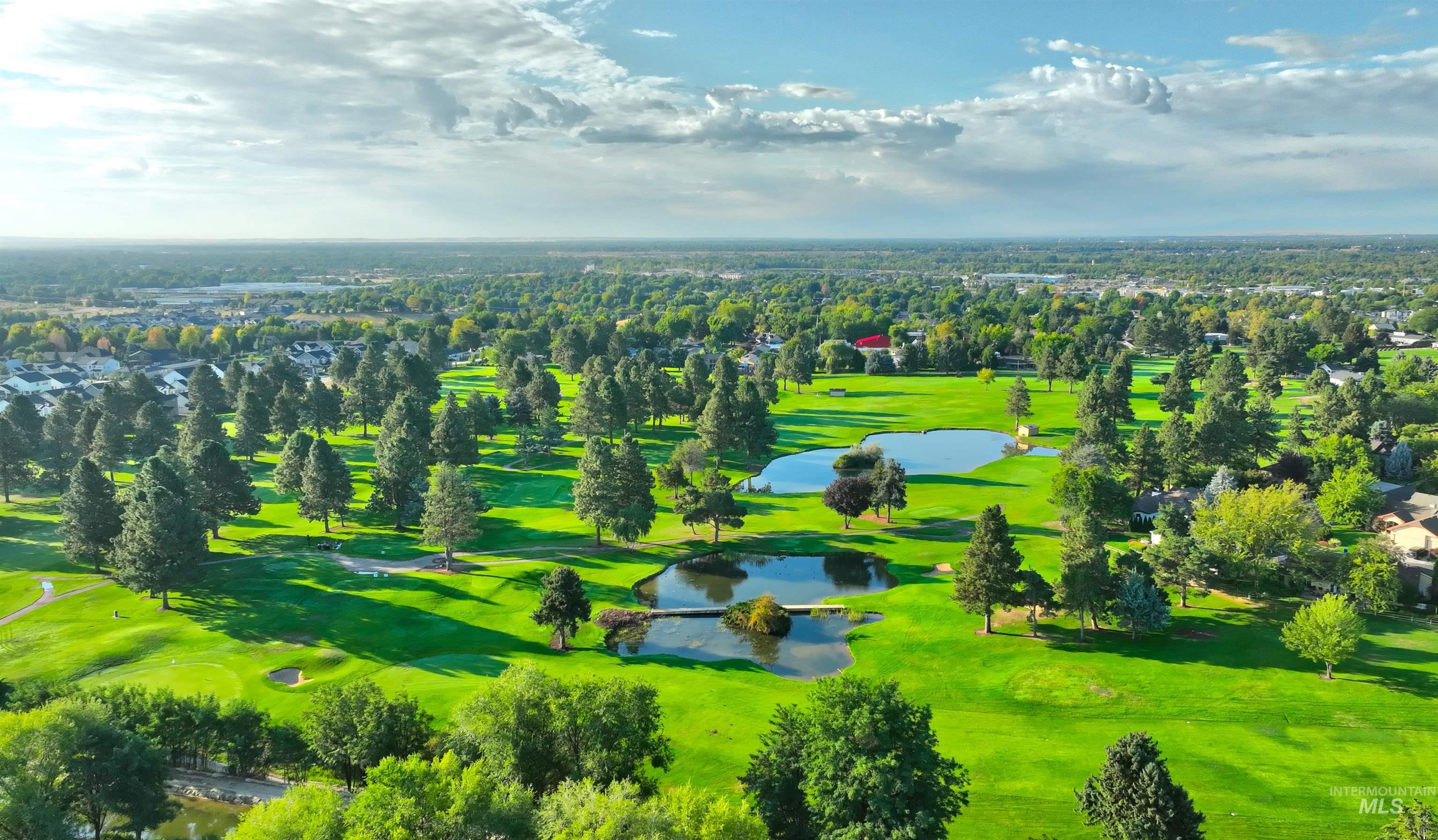 Drone / aerial view of a golf course and a large body of water
