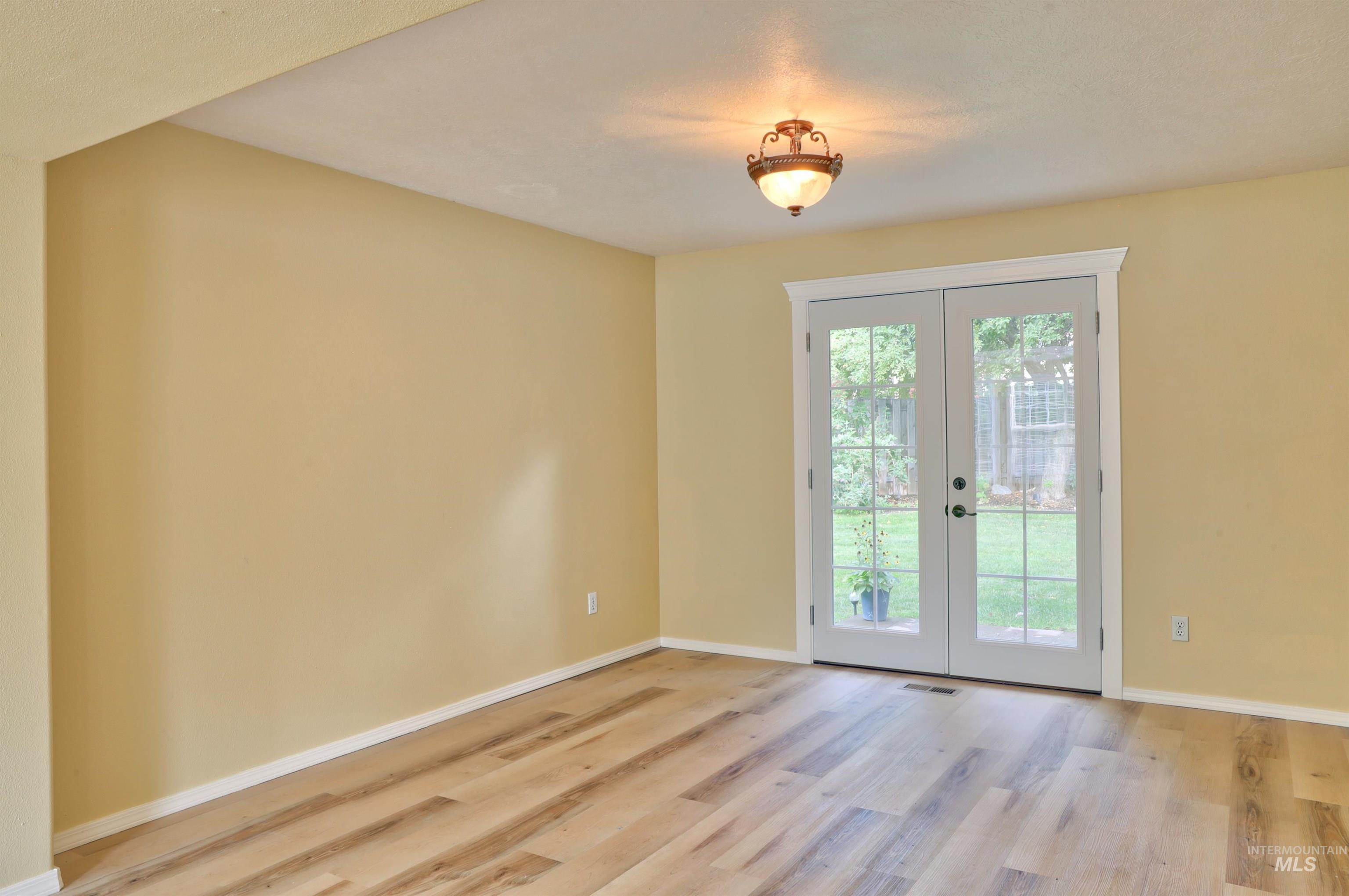 Doorway to outside featuring french doors and wood finished floors