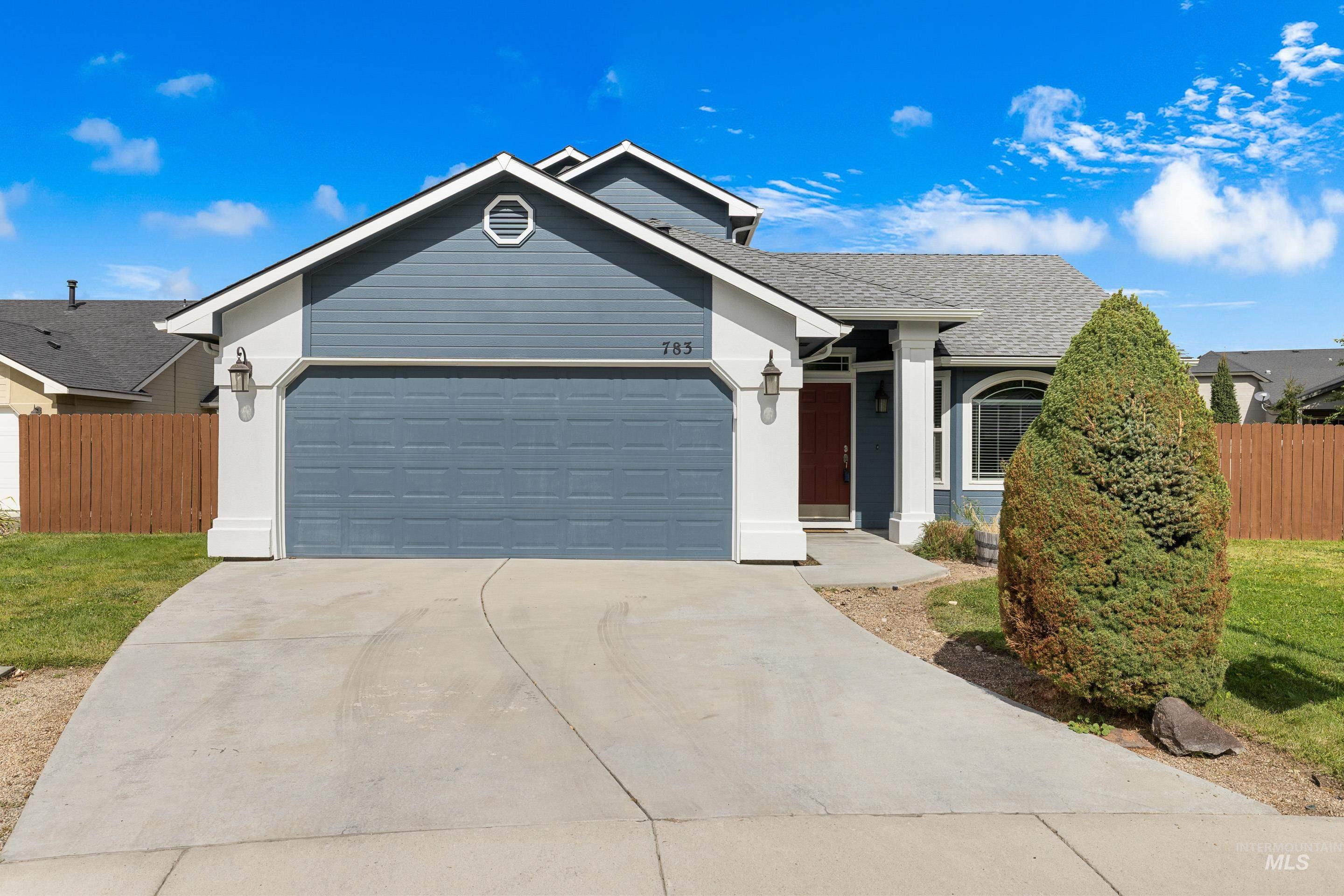 Single story home with roof with shingles, driveway, and a garage