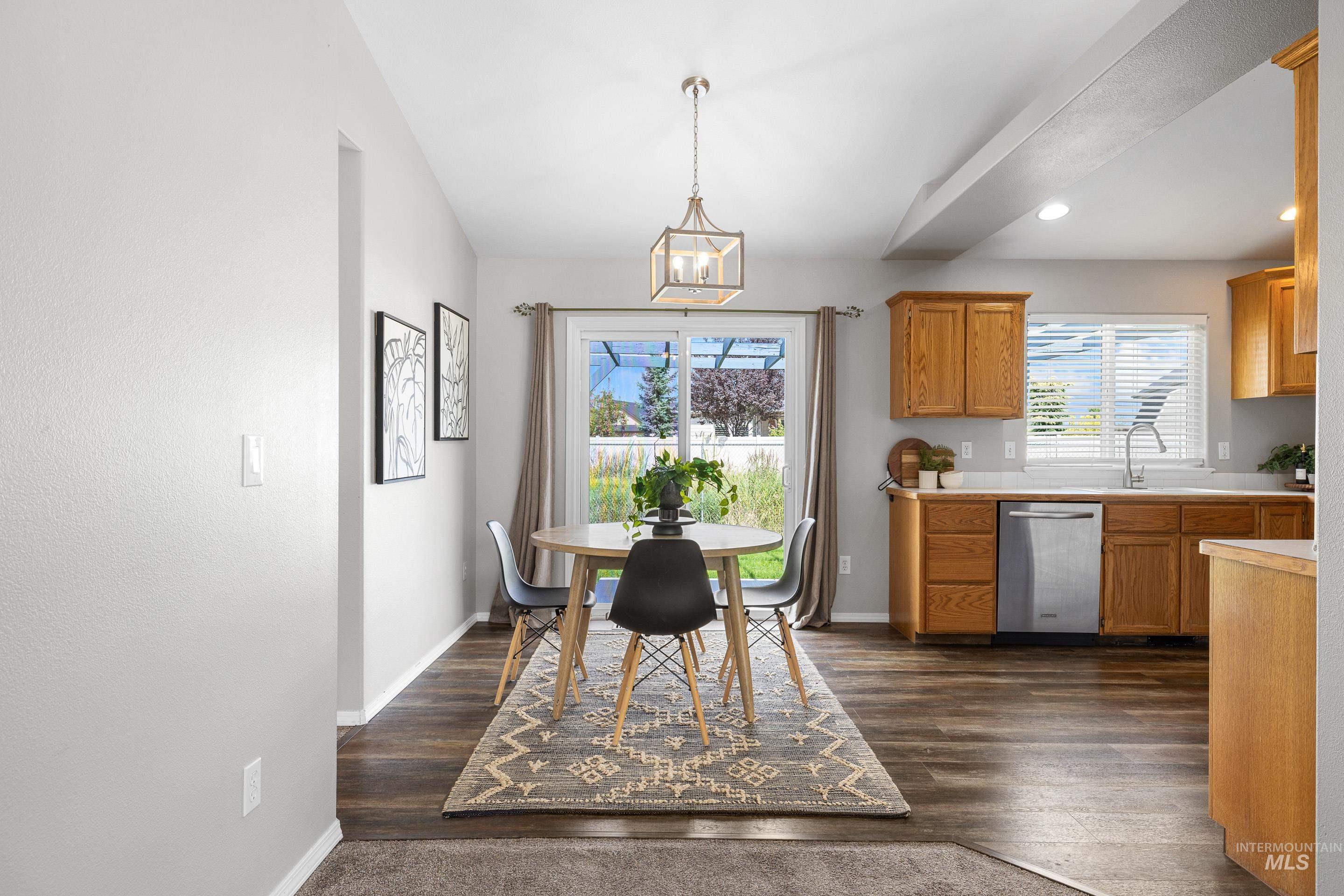 Dining room featuring recessed lighting, dark wood finished floors, and a chandelier