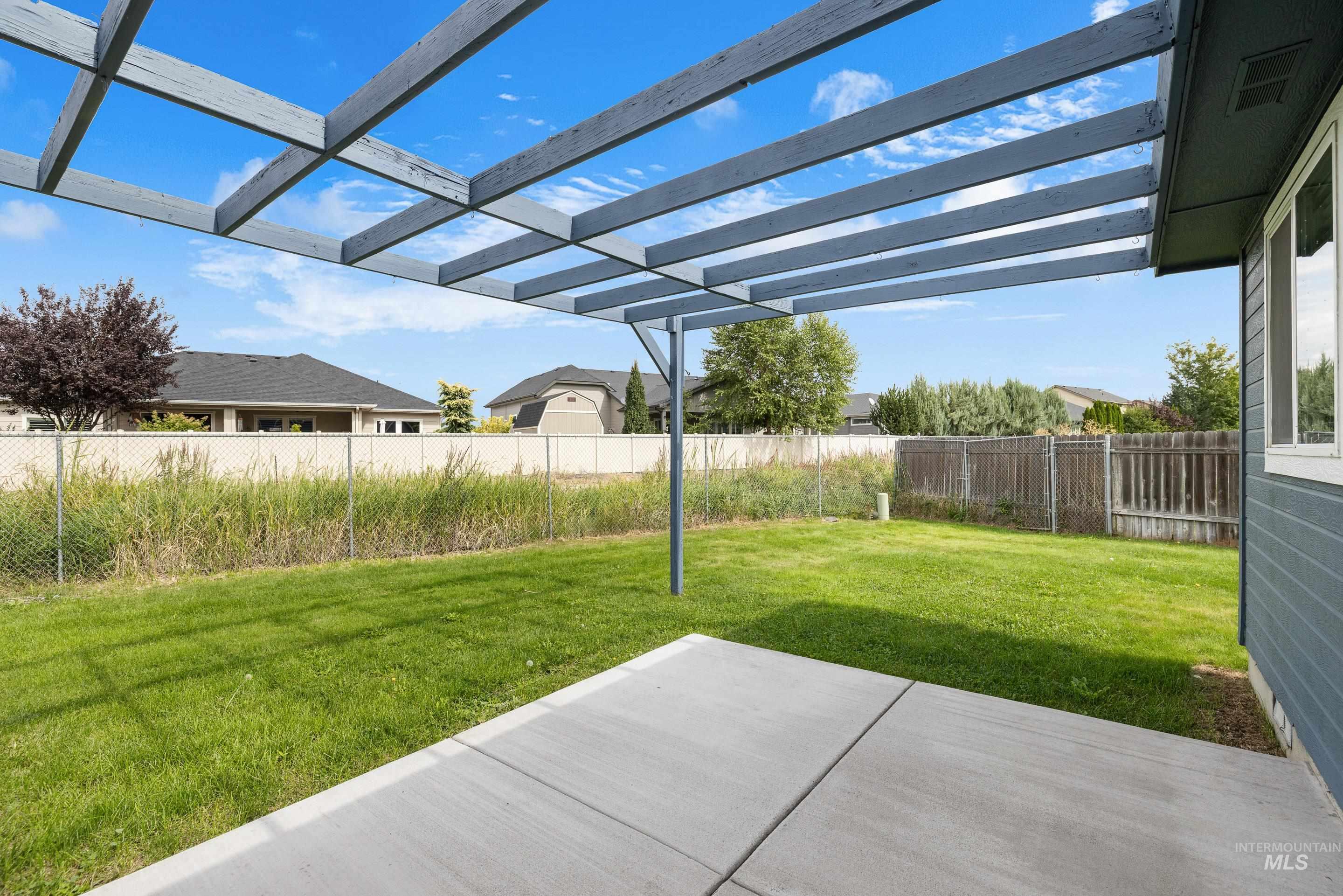 Fenced backyard with a patio area and a pergola