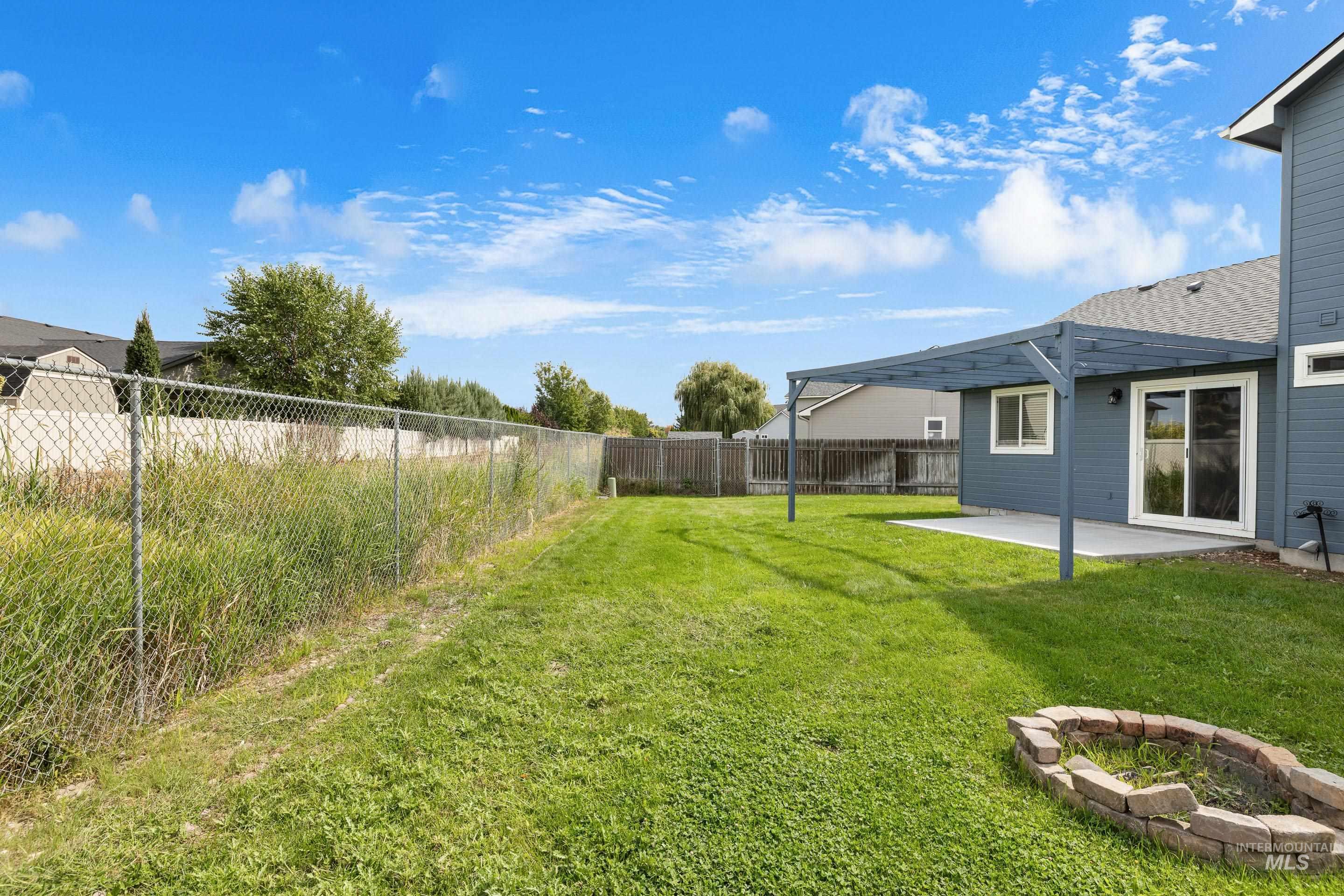 Fenced backyard featuring a patio