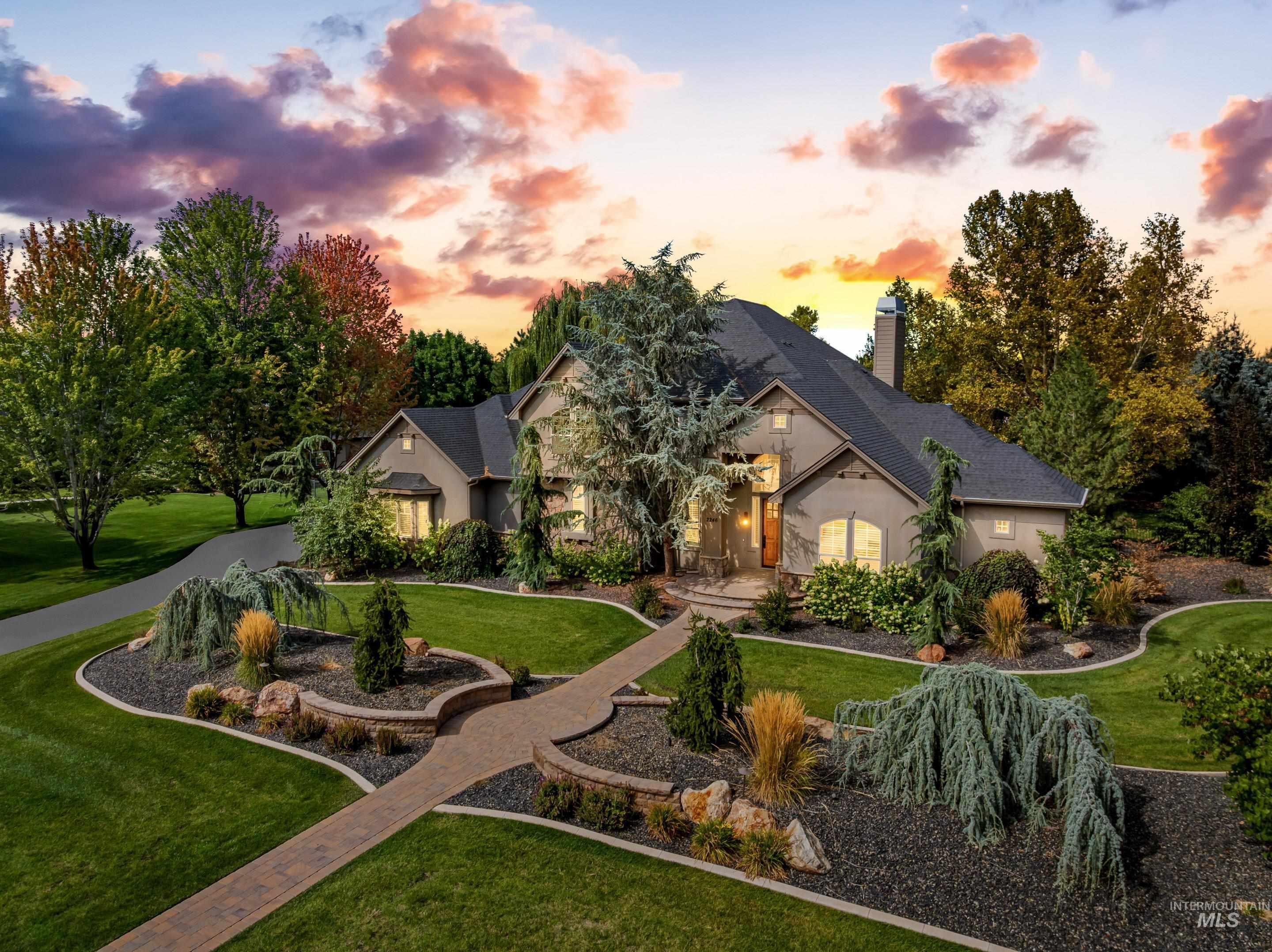 View of front of home featuring a front yard, stucco siding, and a chimney