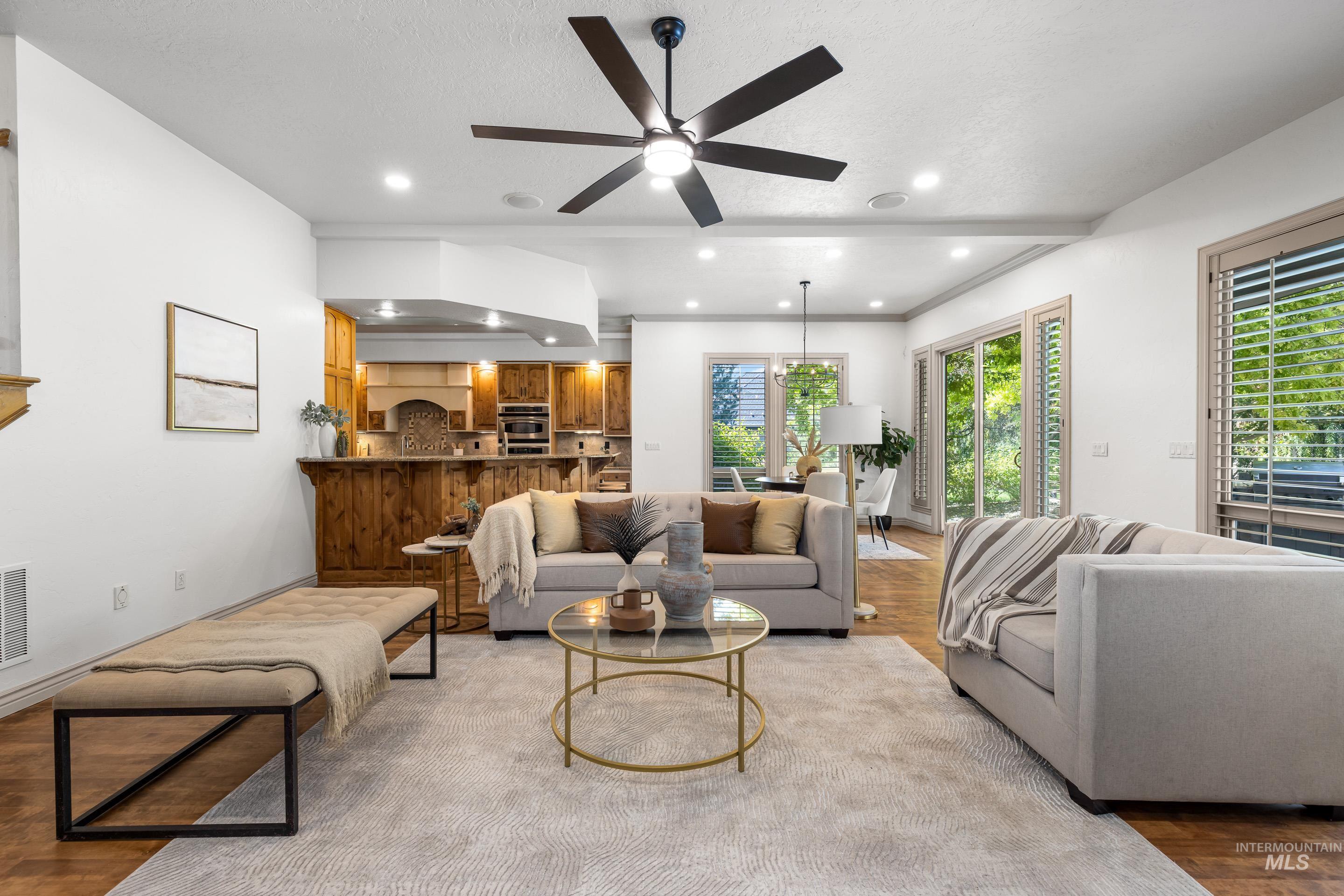 Living room featuring wood finished floors, recessed lighting, ceiling fan, and a textured ceiling