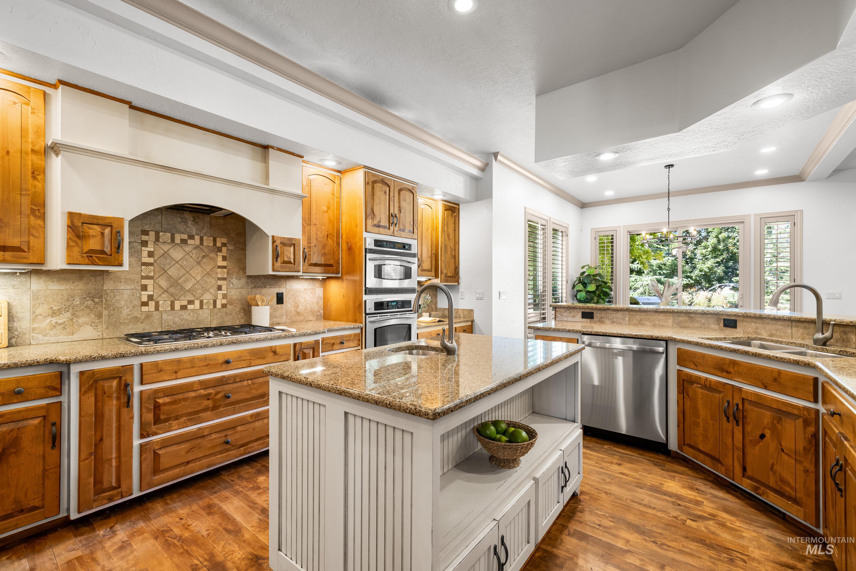 Kitchen featuring brown cabinets, light stone countertops, tasteful backsplash, open shelves, and dark wood finished floors