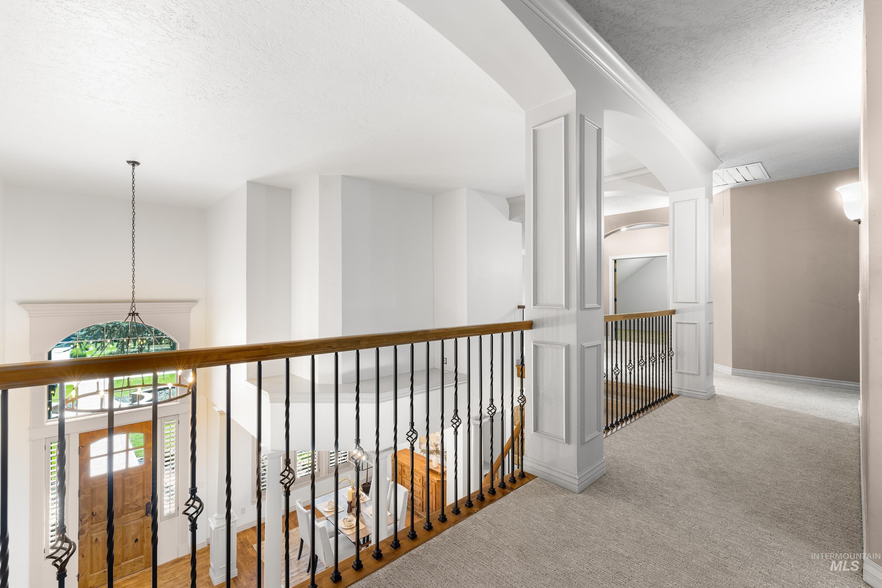 Hall featuring a textured ceiling and carpet floors