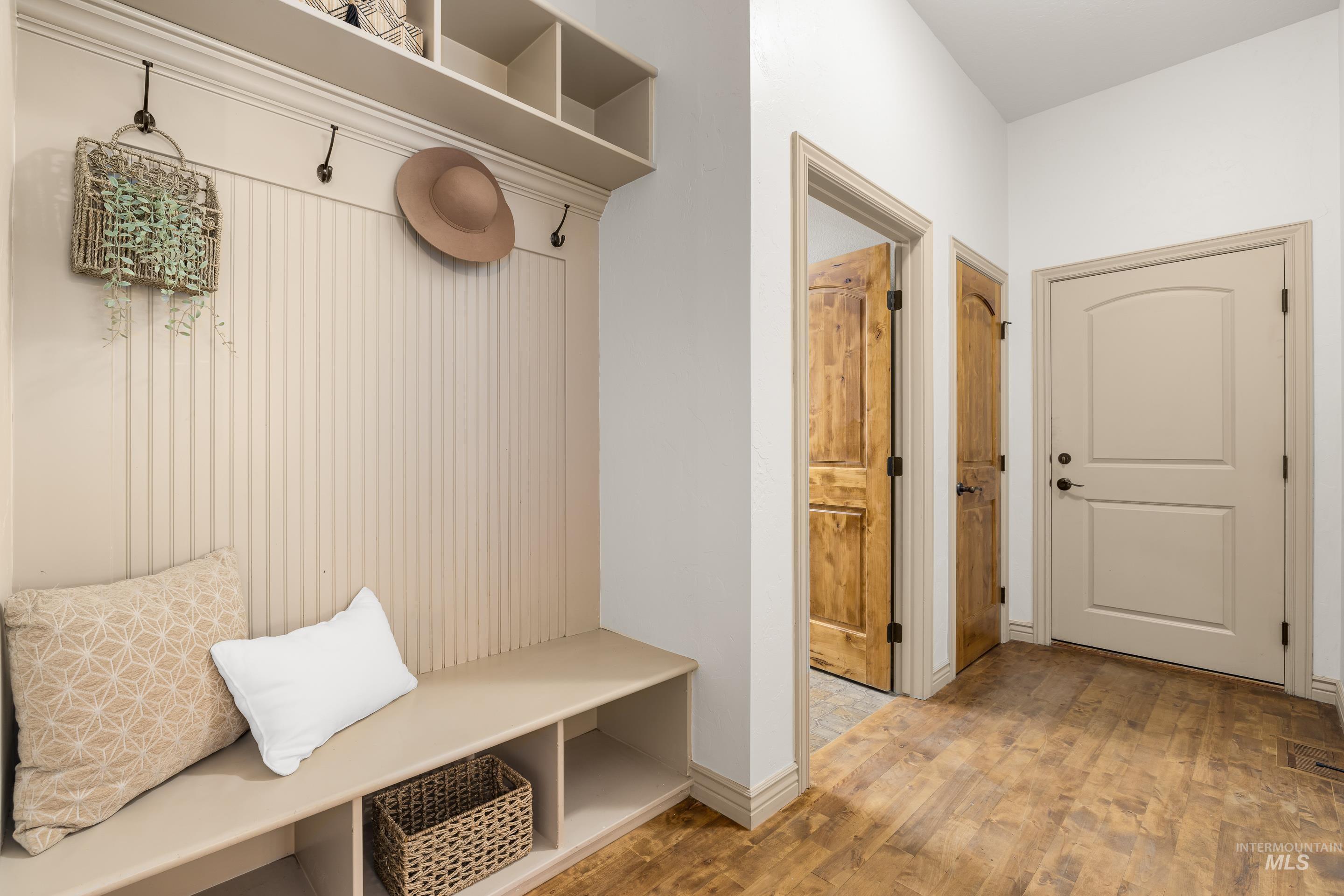 Mudroom featuring light wood-style floors and baseboards