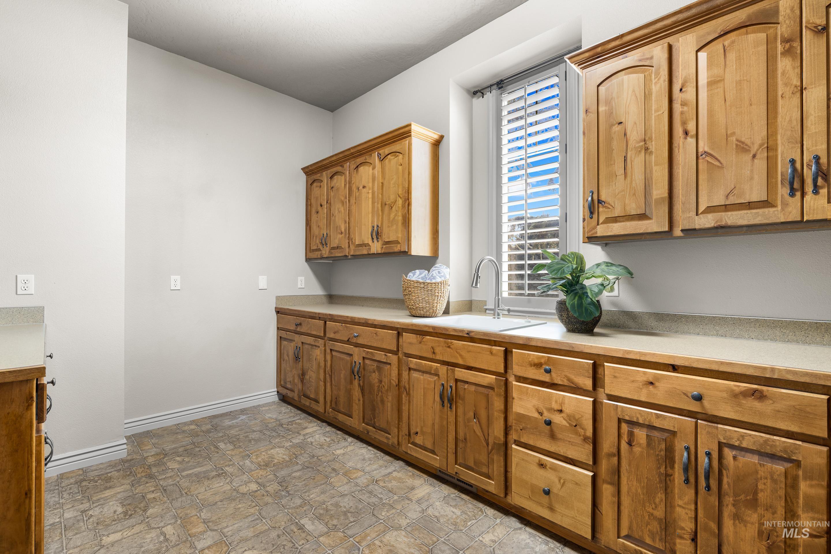 Washroom featuring baseboards and stone finish flooring