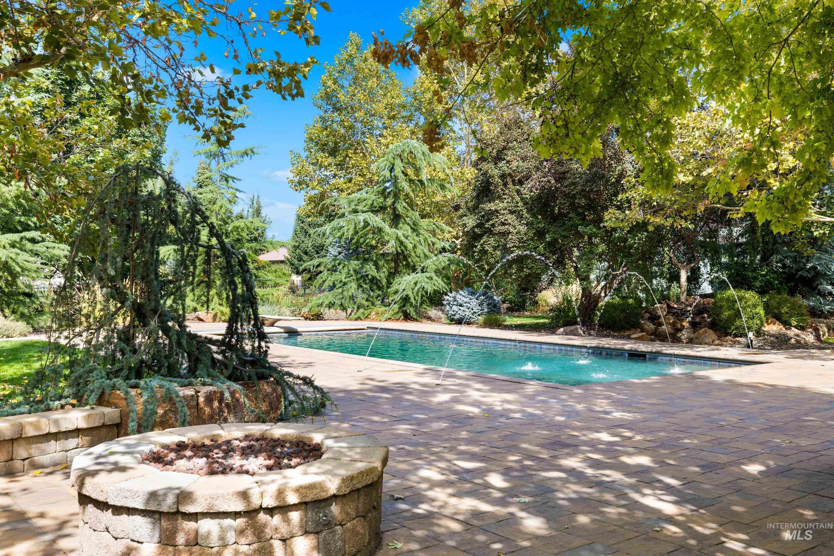 Swimming pool featuring a fire pit and a patio area