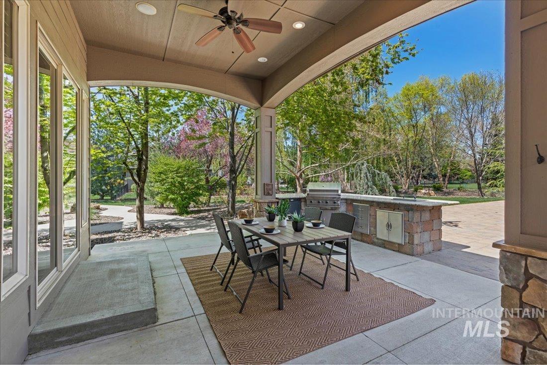 View of patio / terrace featuring an outdoor kitchen, outdoor dining space, and ceiling fan