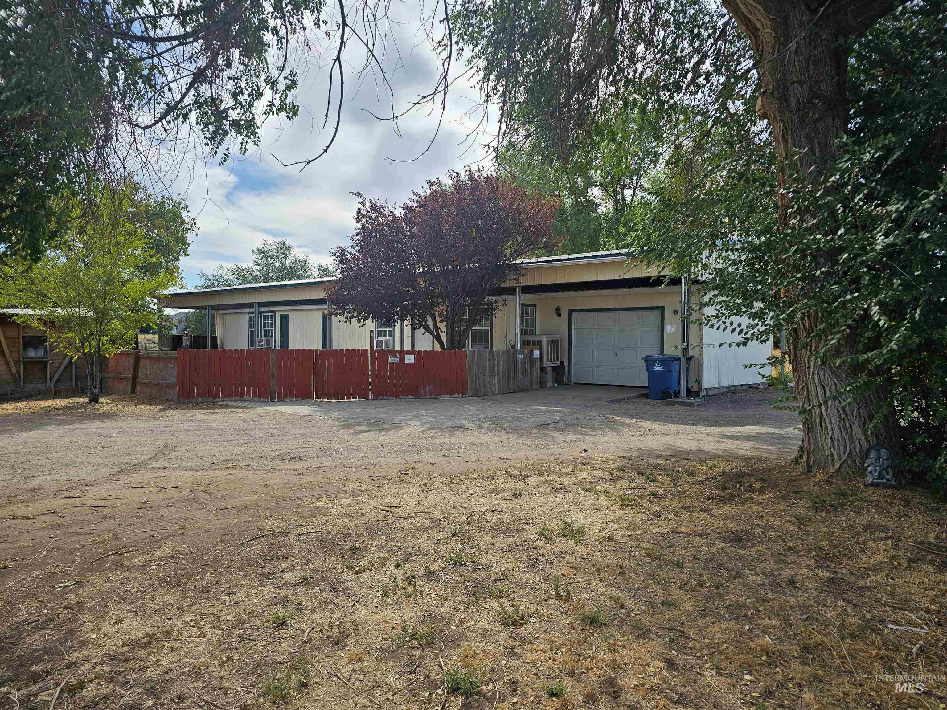 View of front of property featuring an attached garage and driveway