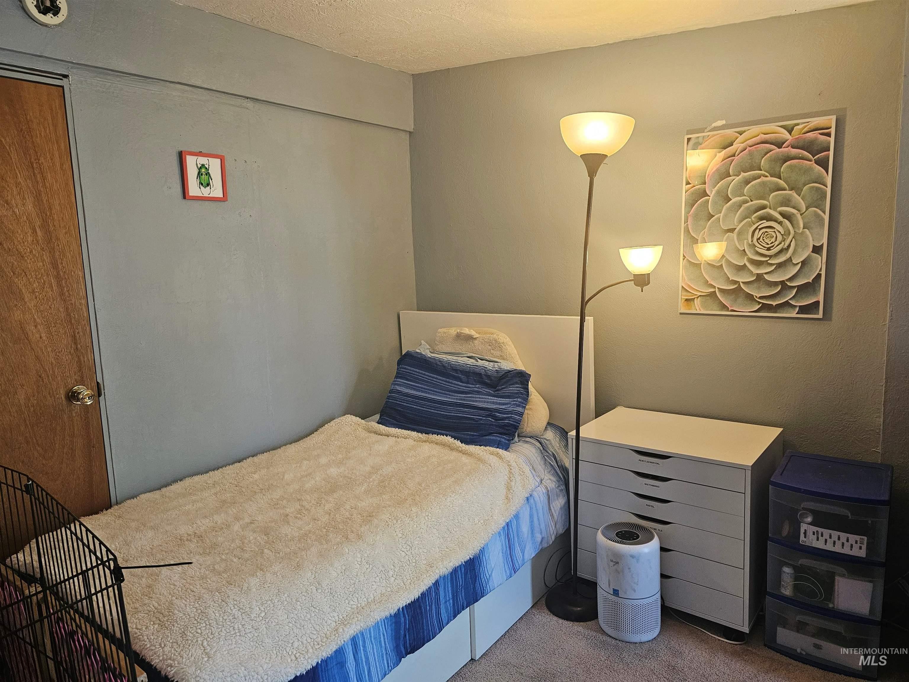 Bedroom with carpet and a textured ceiling