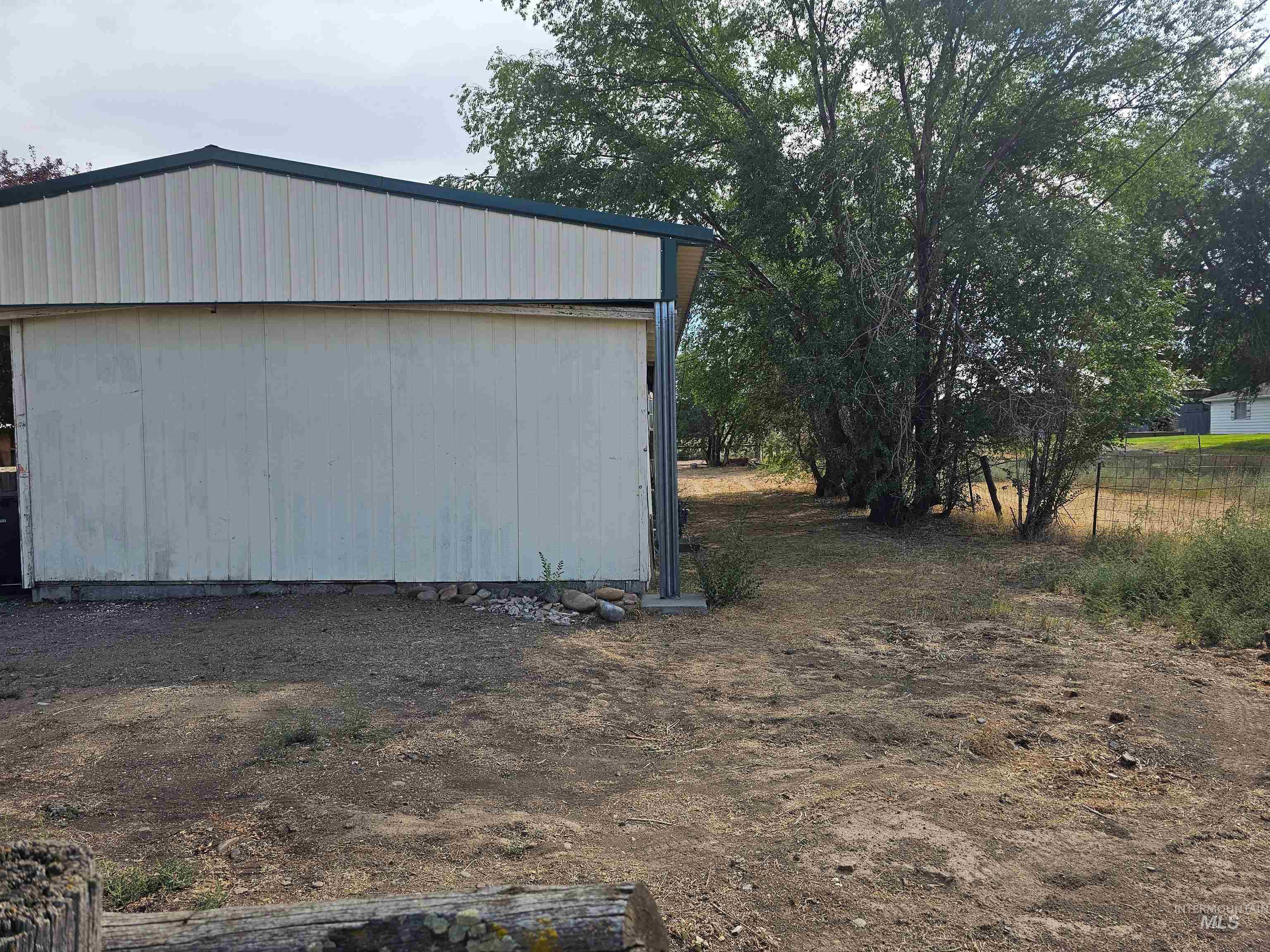 View of side of property with an outdoor structure