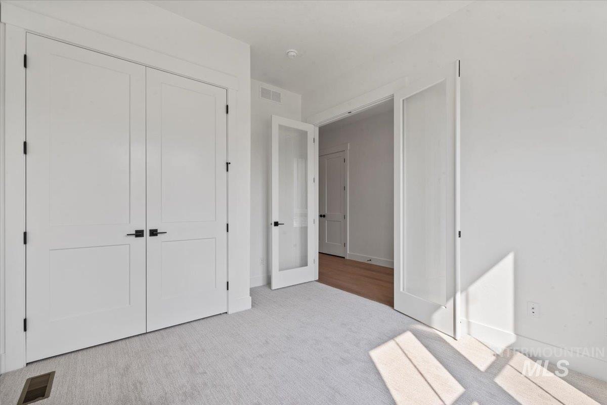Unfurnished bedroom with carpet floors and a closet