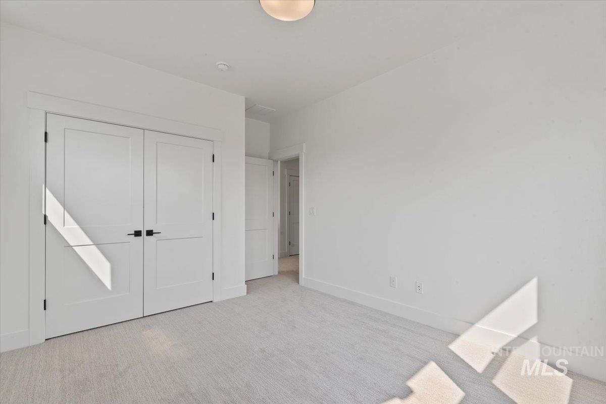 Unfurnished bedroom featuring carpet flooring and a closet