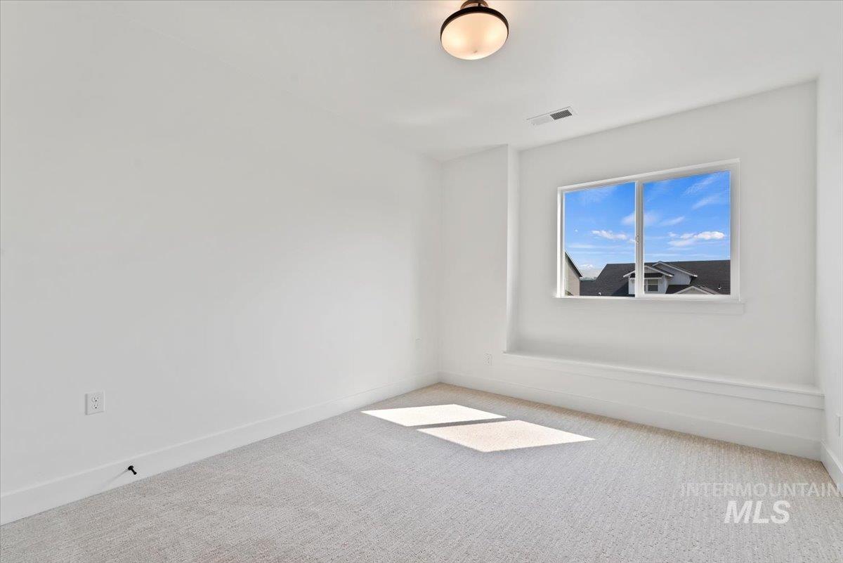 Empty room with carpet flooring and baseboards