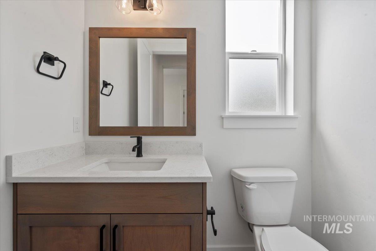 Half bath featuring vanity and toilet