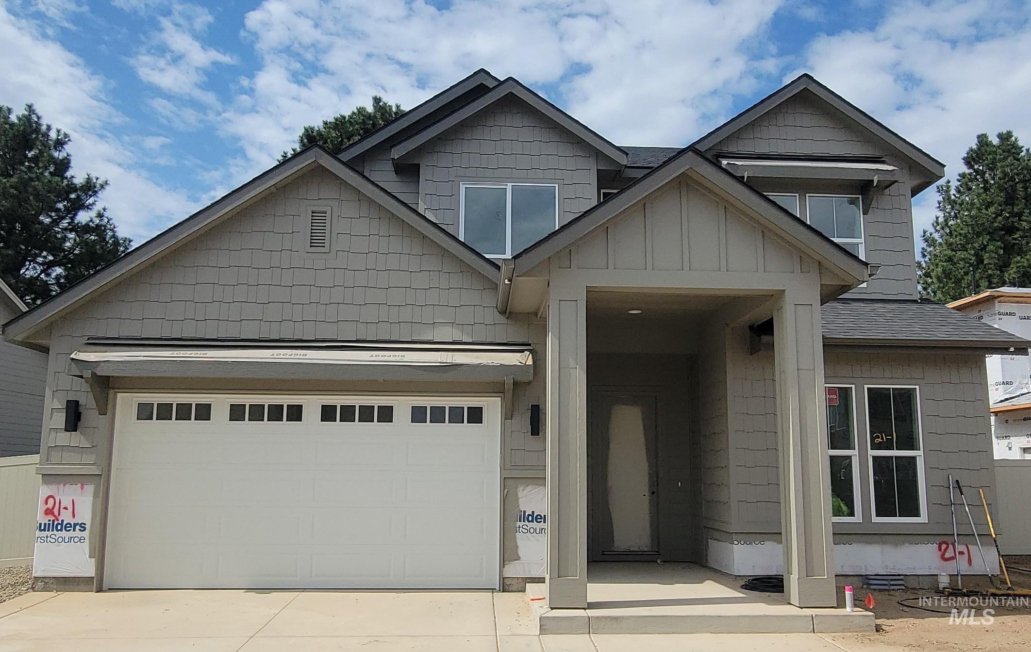 Craftsman inspired home with concrete driveway, an attached garage, and board and batten siding