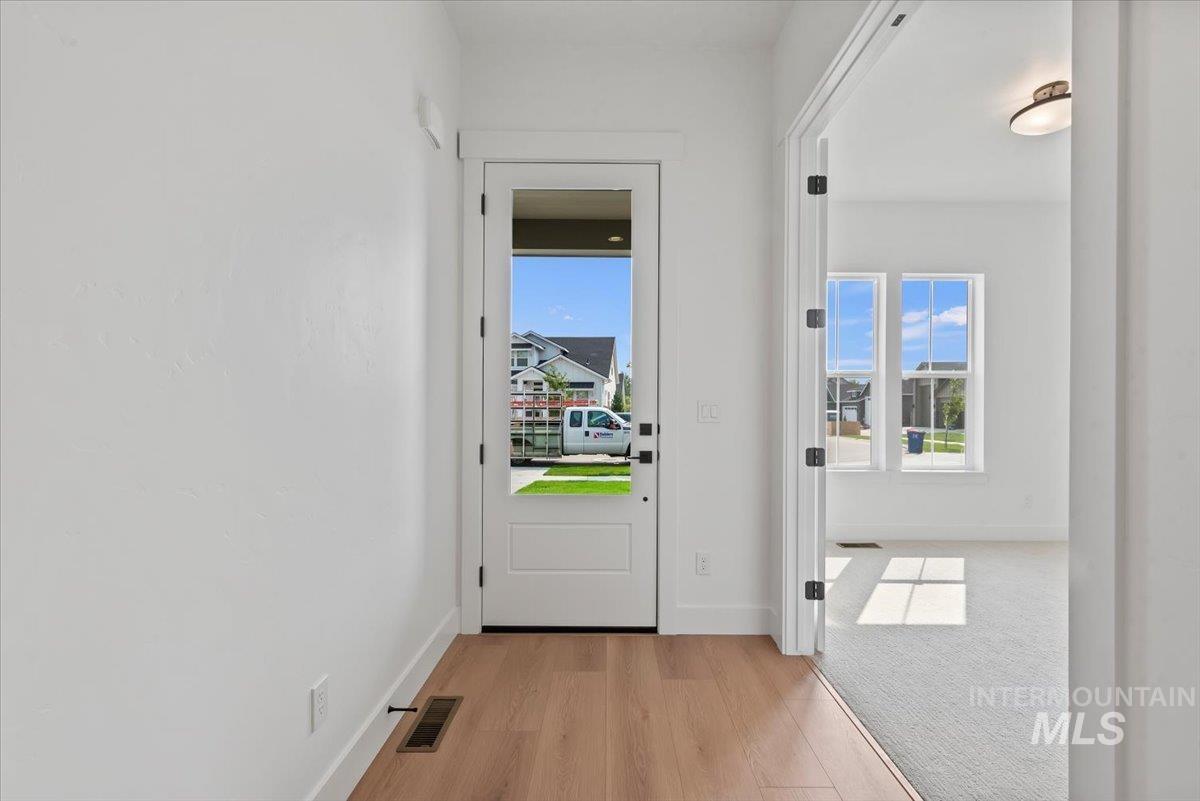Entryway with baseboards and wood finished floors