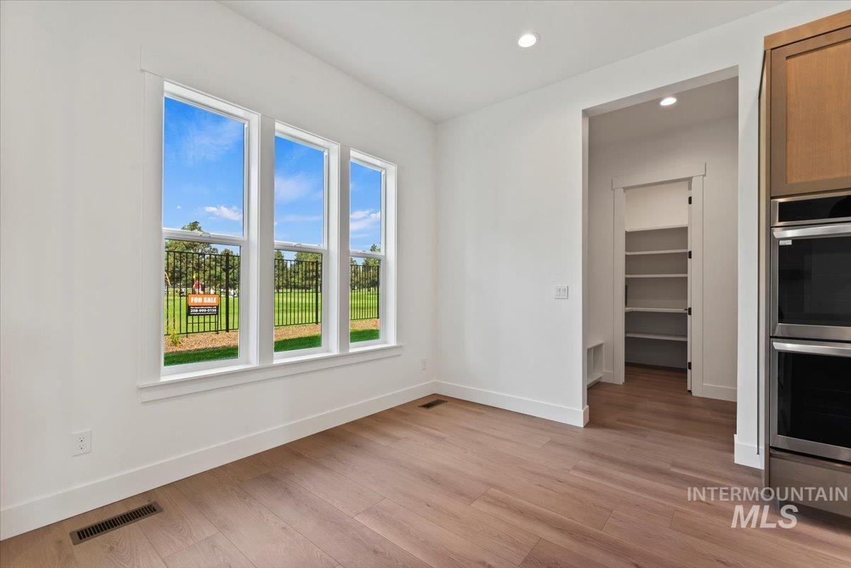 Unfurnished dining area with recessed lighting and light wood-style floors