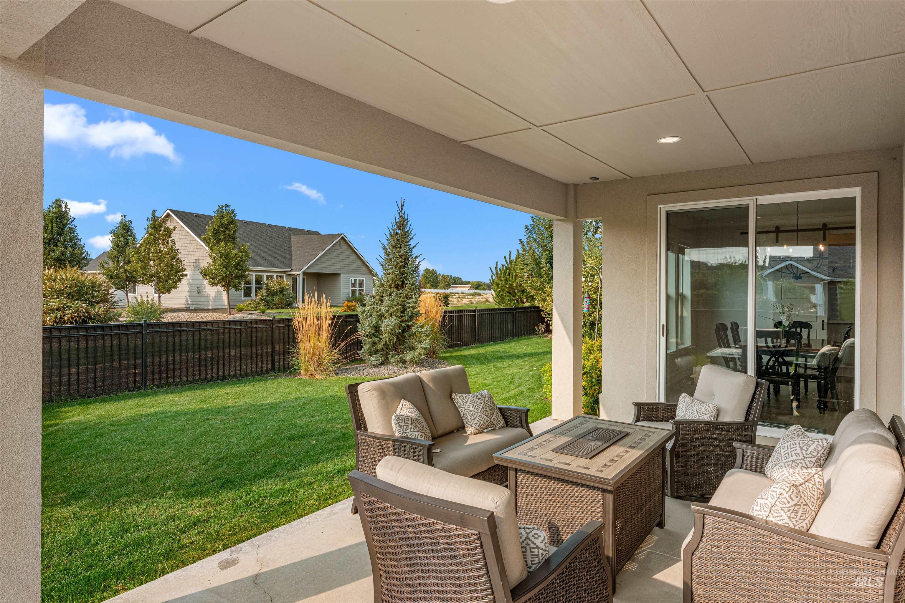 Fenced backyard featuring a patio area and an outdoor hangout area