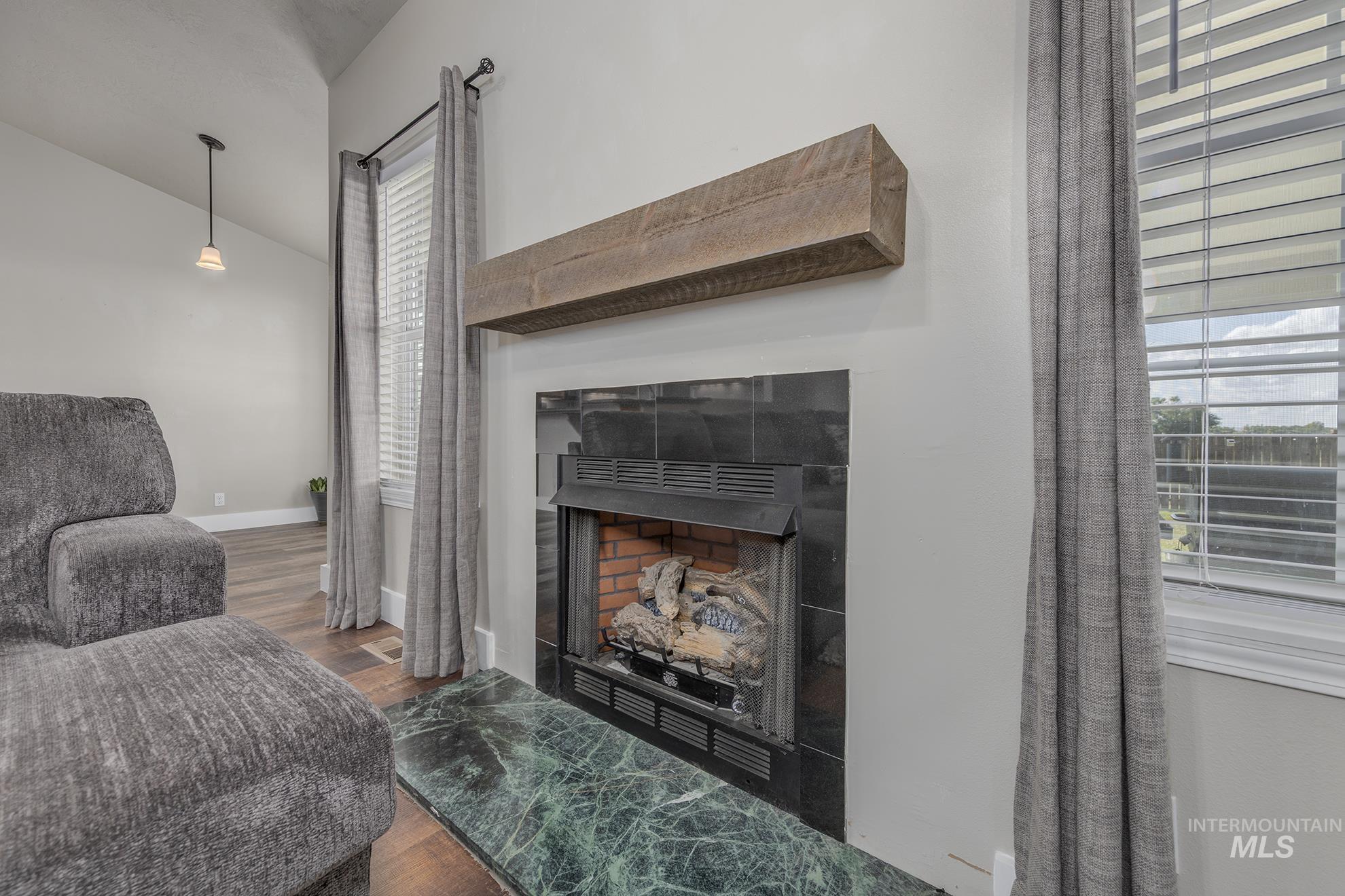 a fireplace, vaulted ceiling in living room
