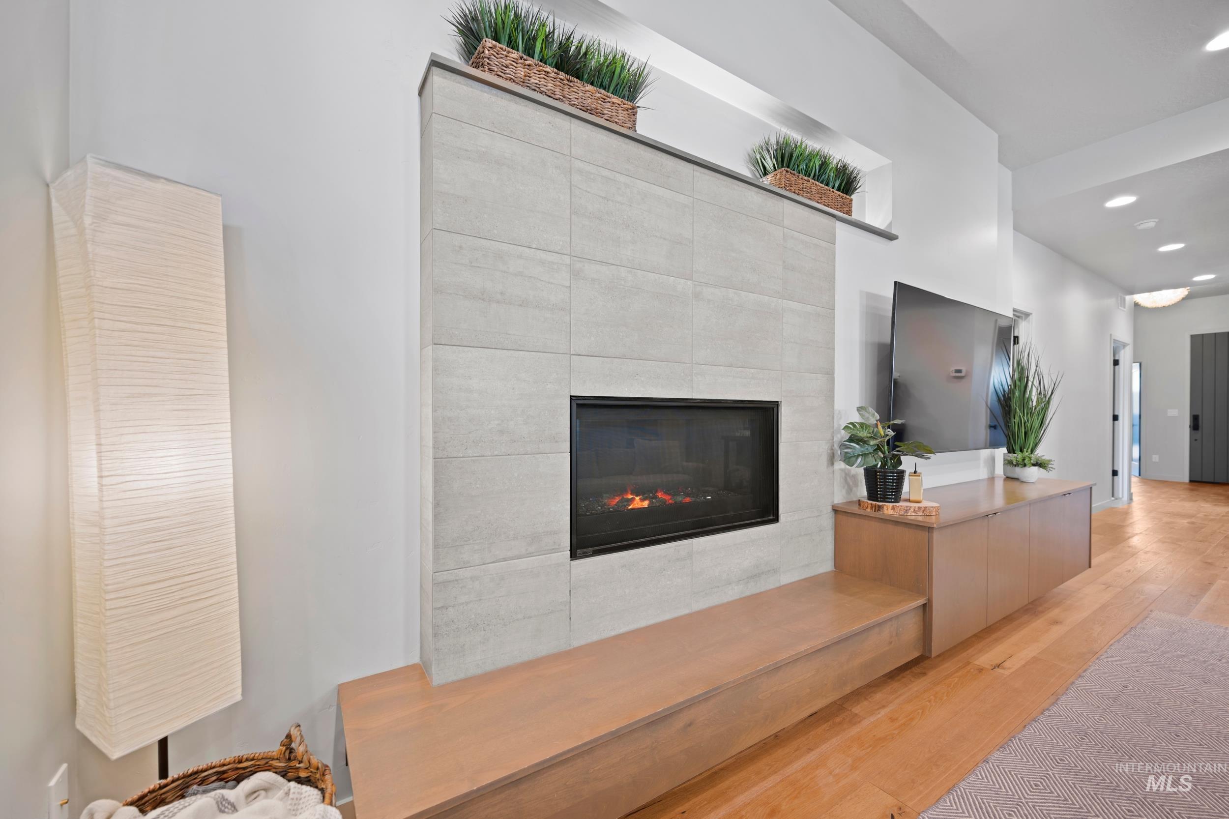Reception area featuring a tile fireplace and recessed lighting