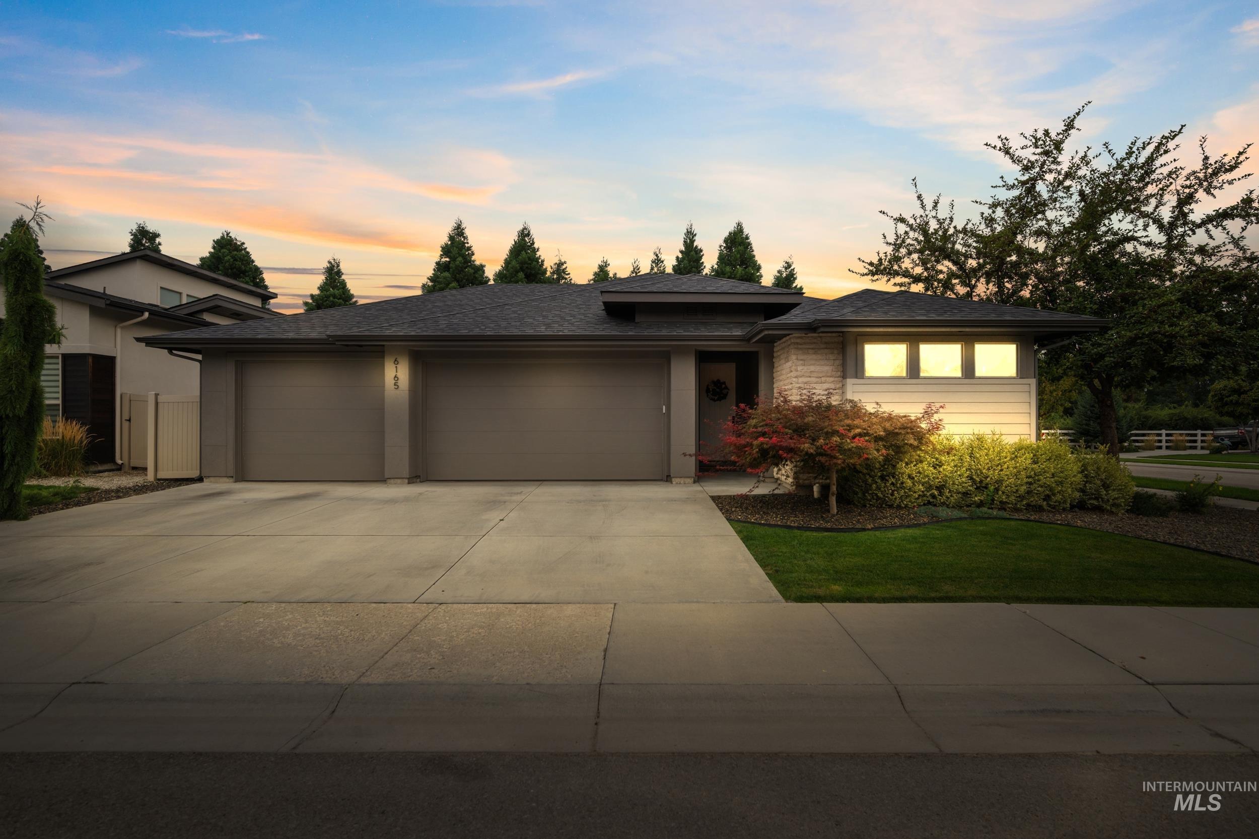 Prairie-style home featuring concrete driveway, an attached garage, and a shingled roof