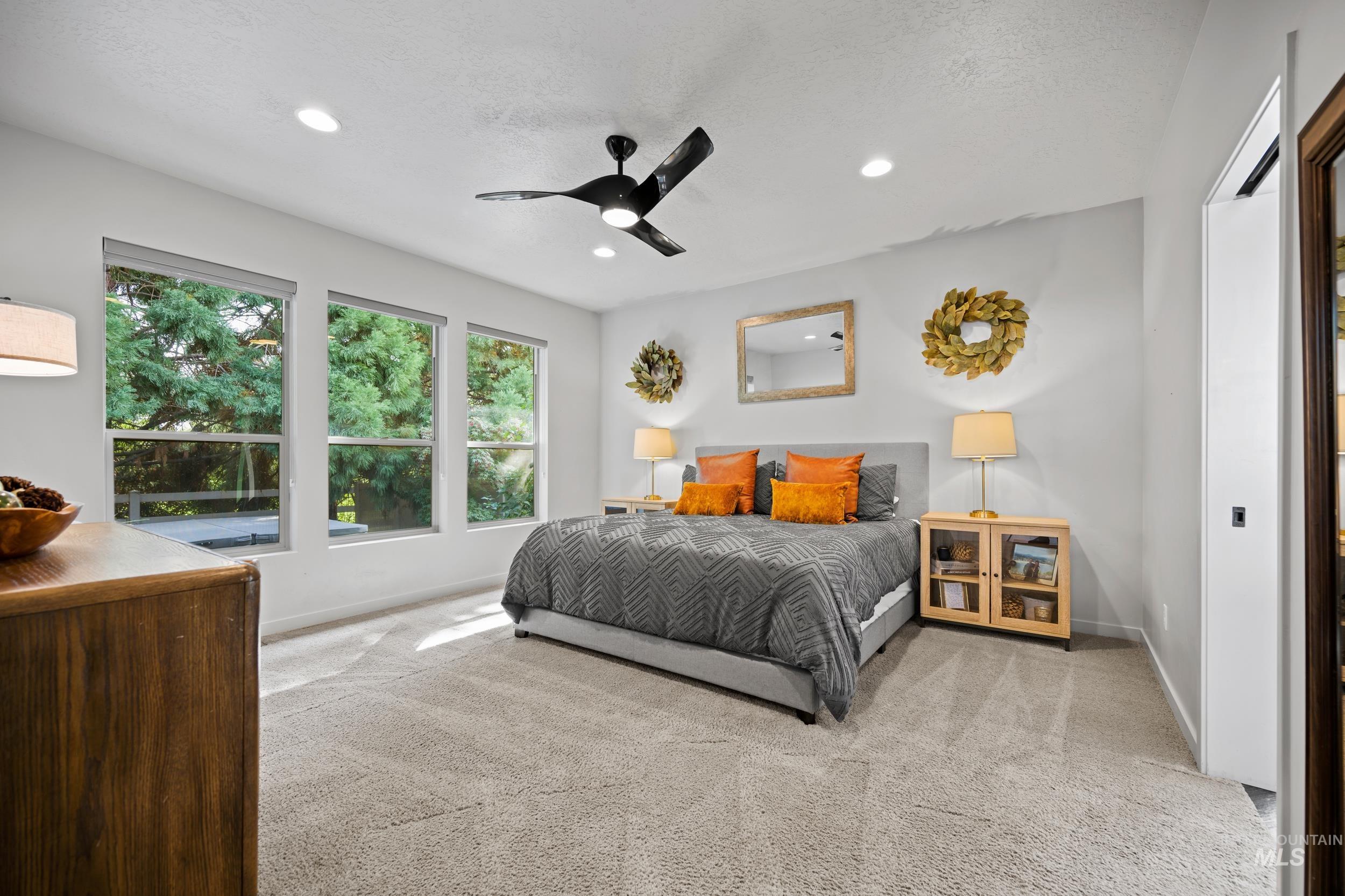 Bedroom featuring carpet floors, recessed lighting, ceiling fan, and a textured ceiling
