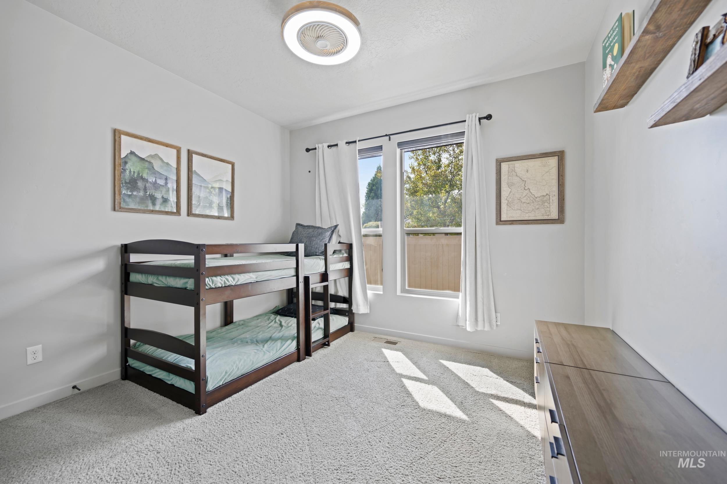 Bedroom with light carpet and baseboards
