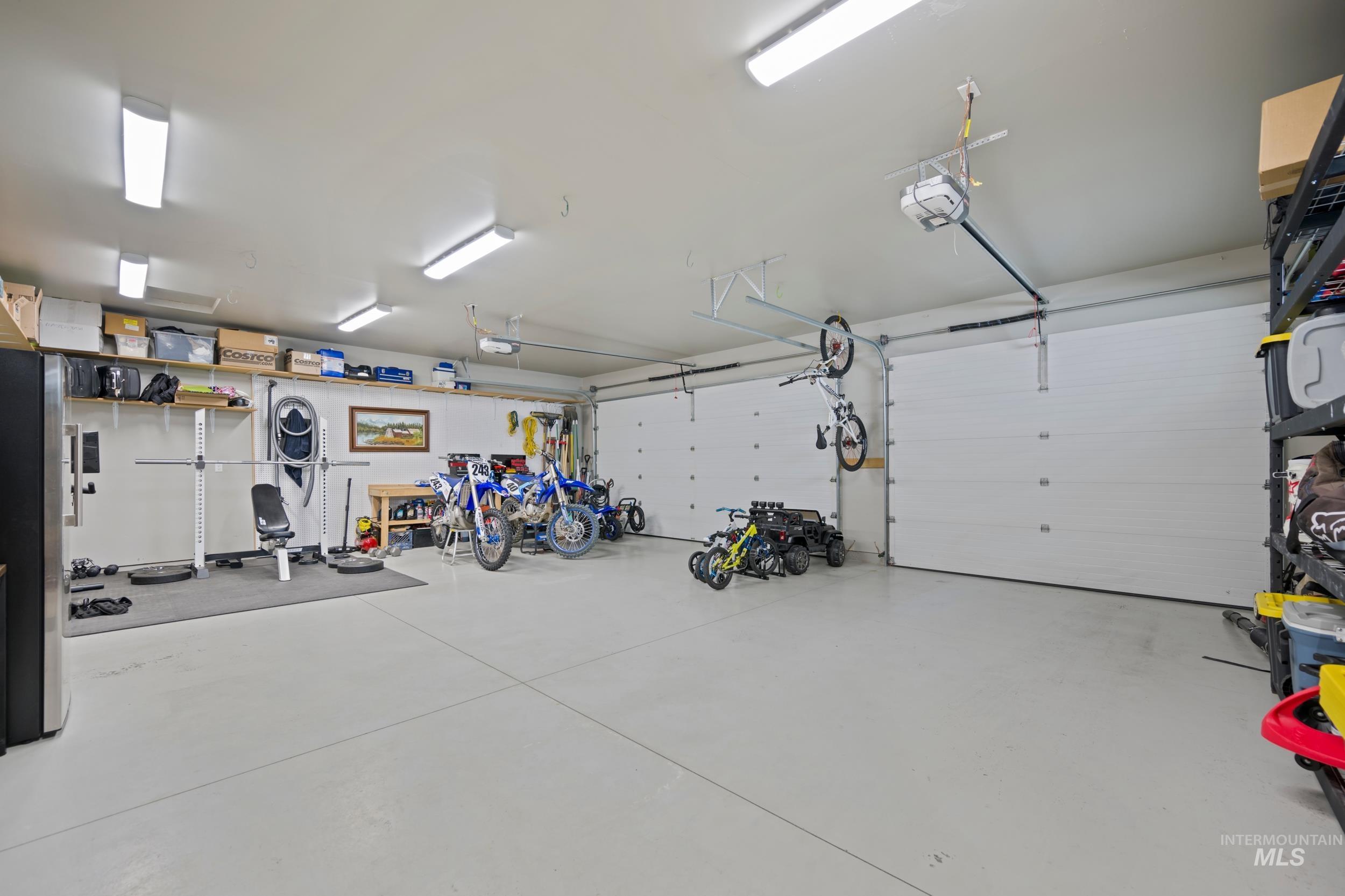 Garage with freestanding refrigerator and a garage door opener