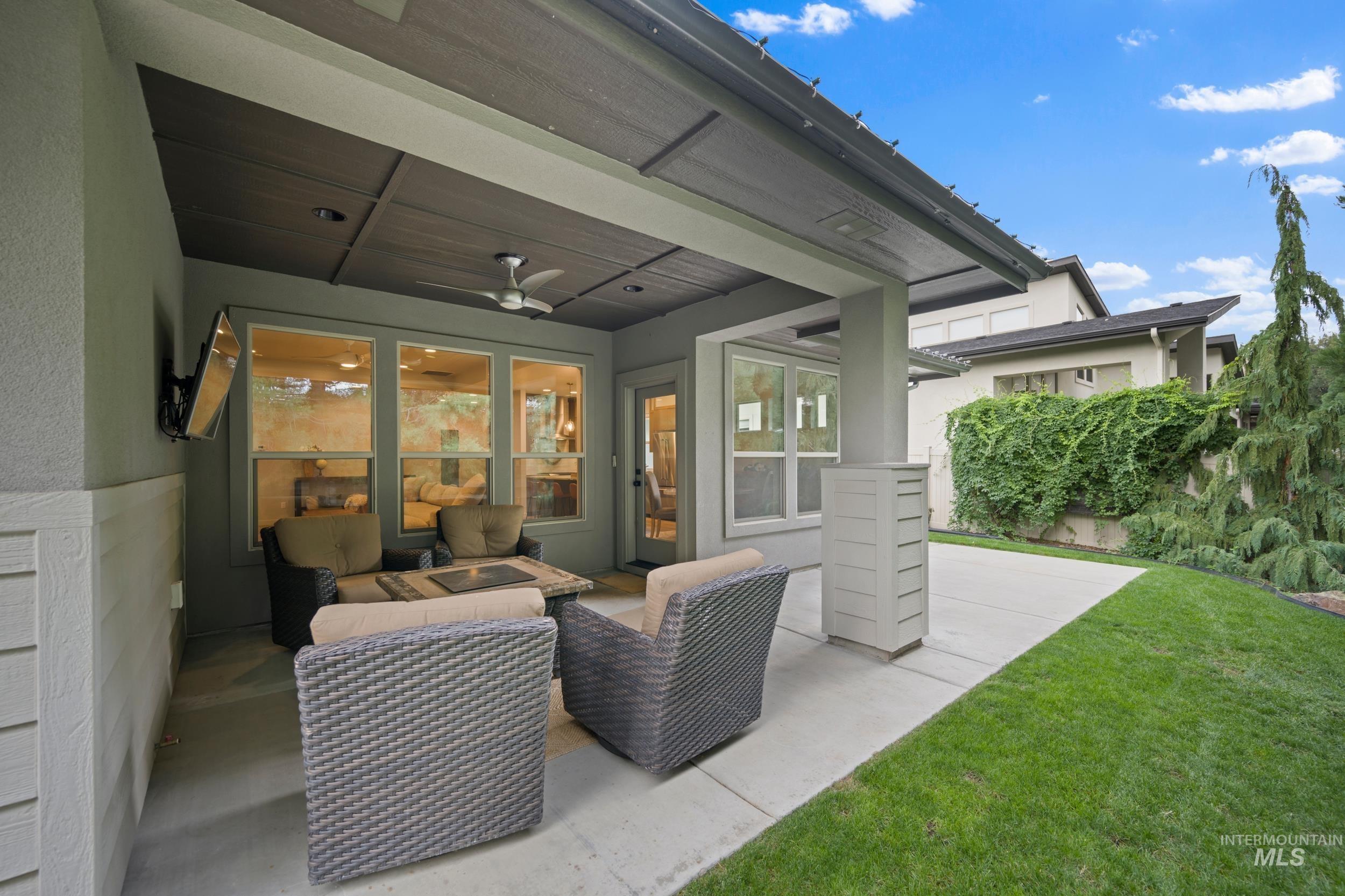 View of patio with an outdoor hangout area and a ceiling fan