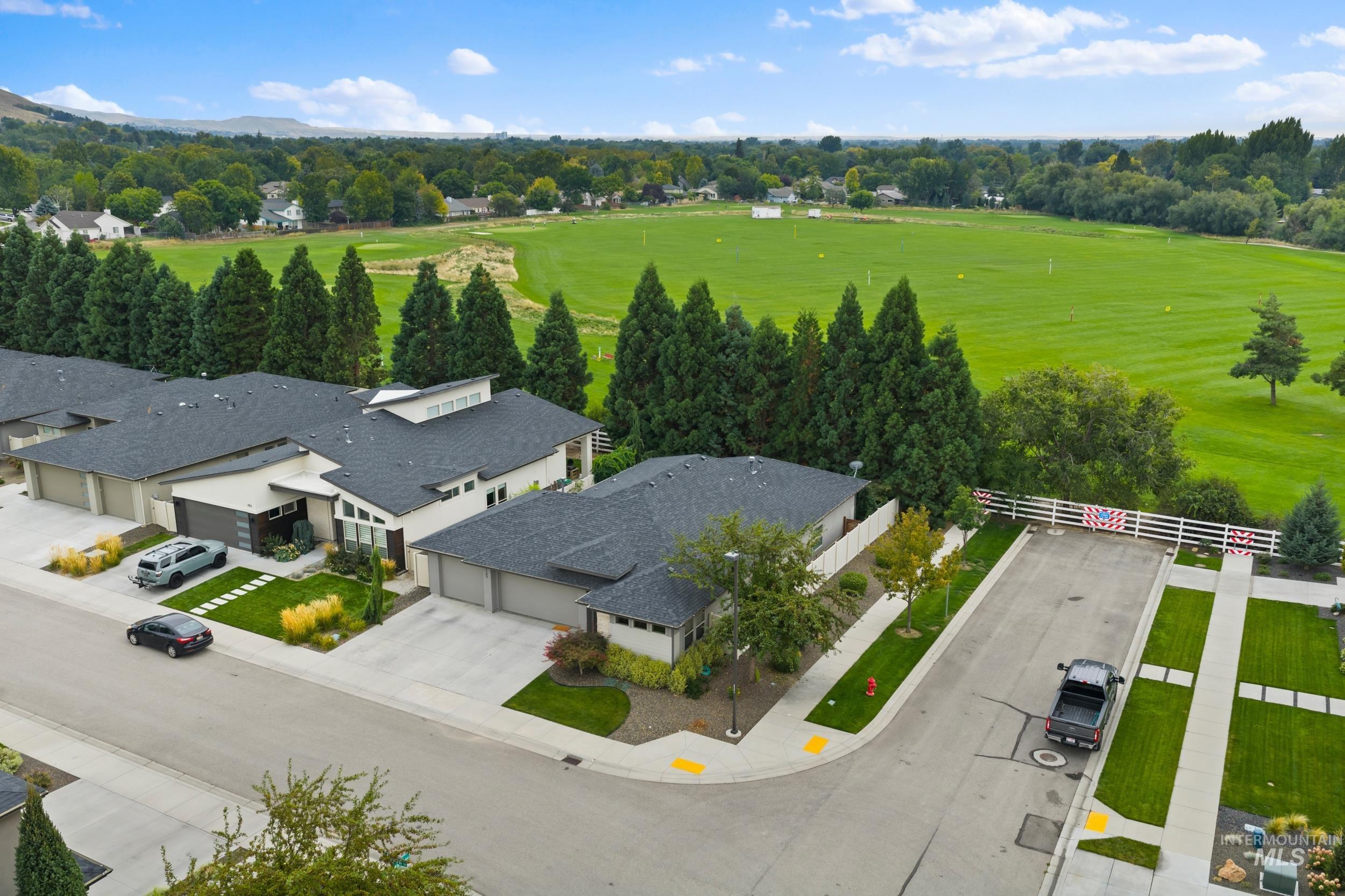 Aerial view of residential area featuring a tree filled landscape