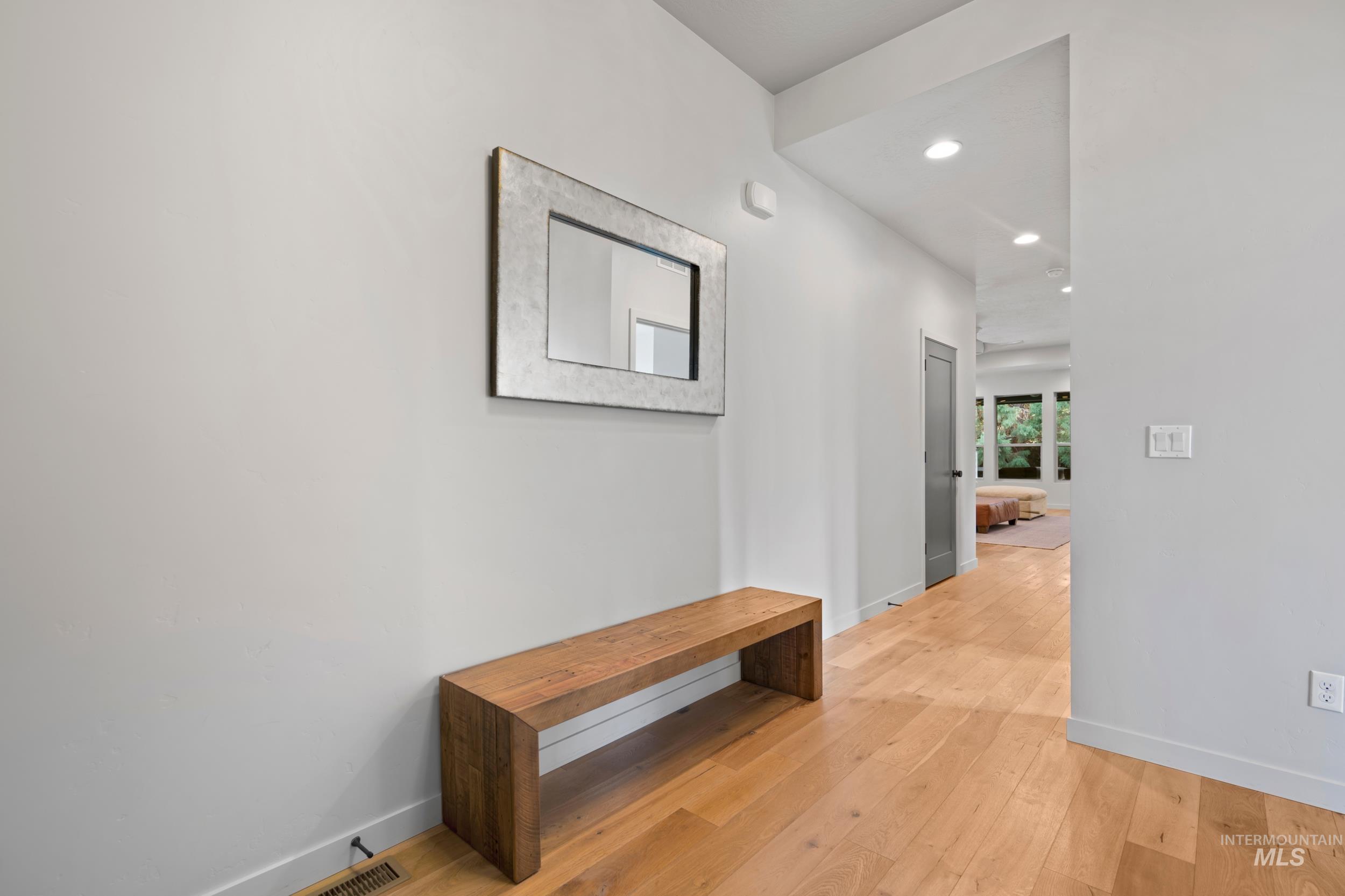 Hall with recessed lighting and light wood-style flooring