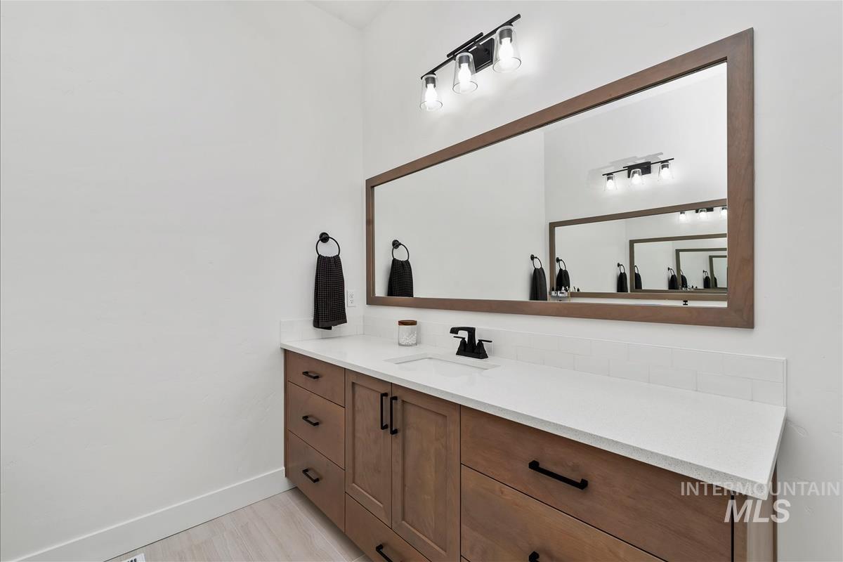 Bathroom featuring vanity and baseboards
