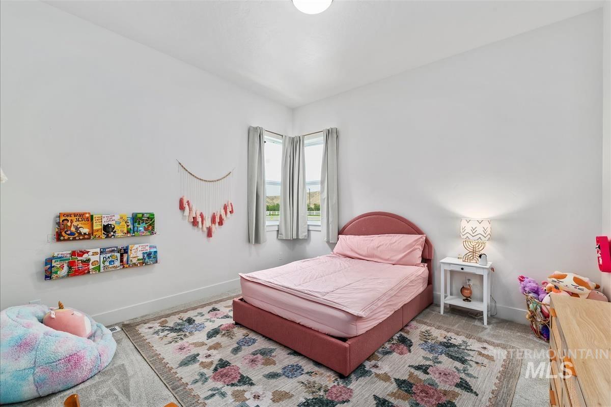 Carpeted bedroom featuring baseboards