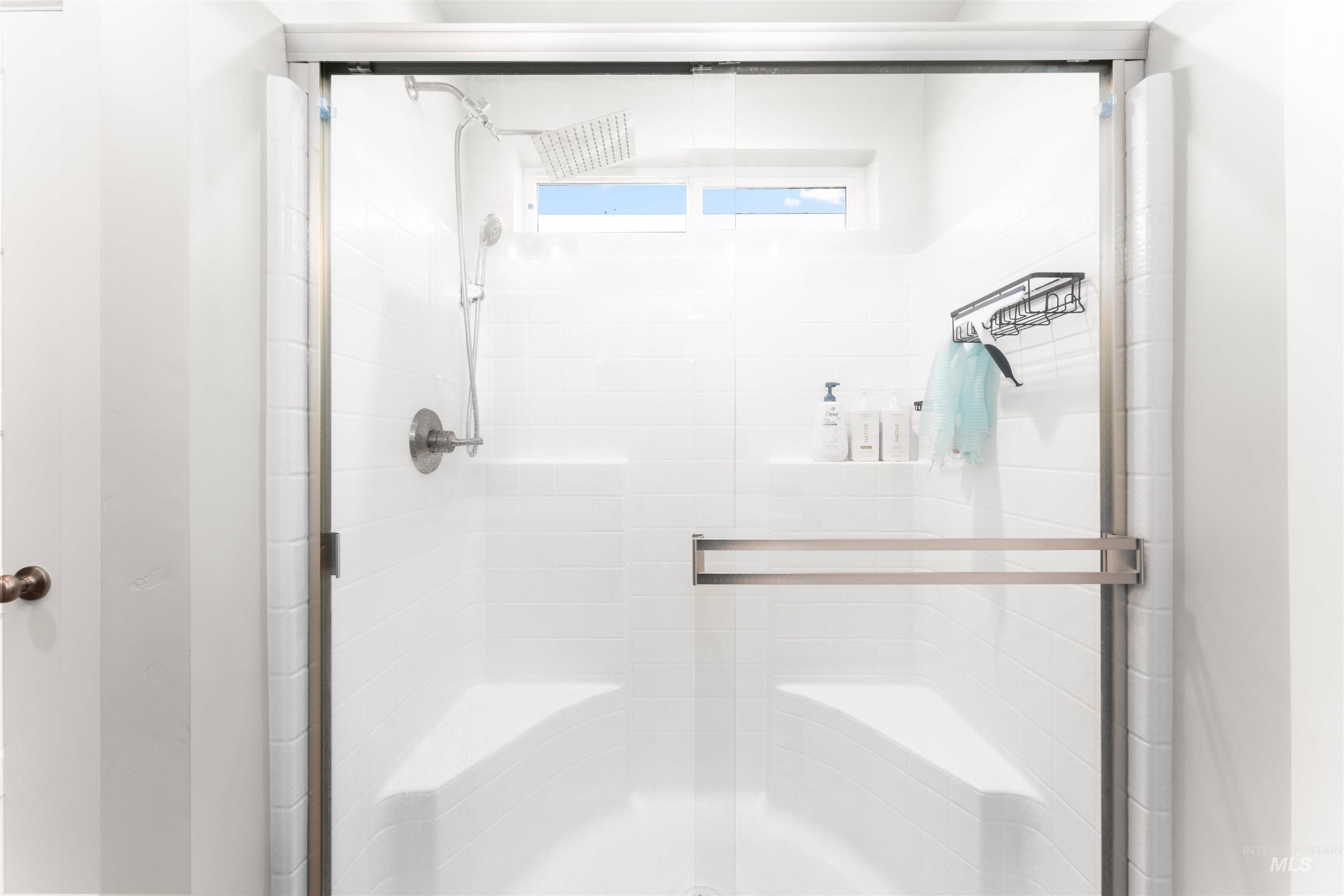 Full bathroom featuring a shower stall