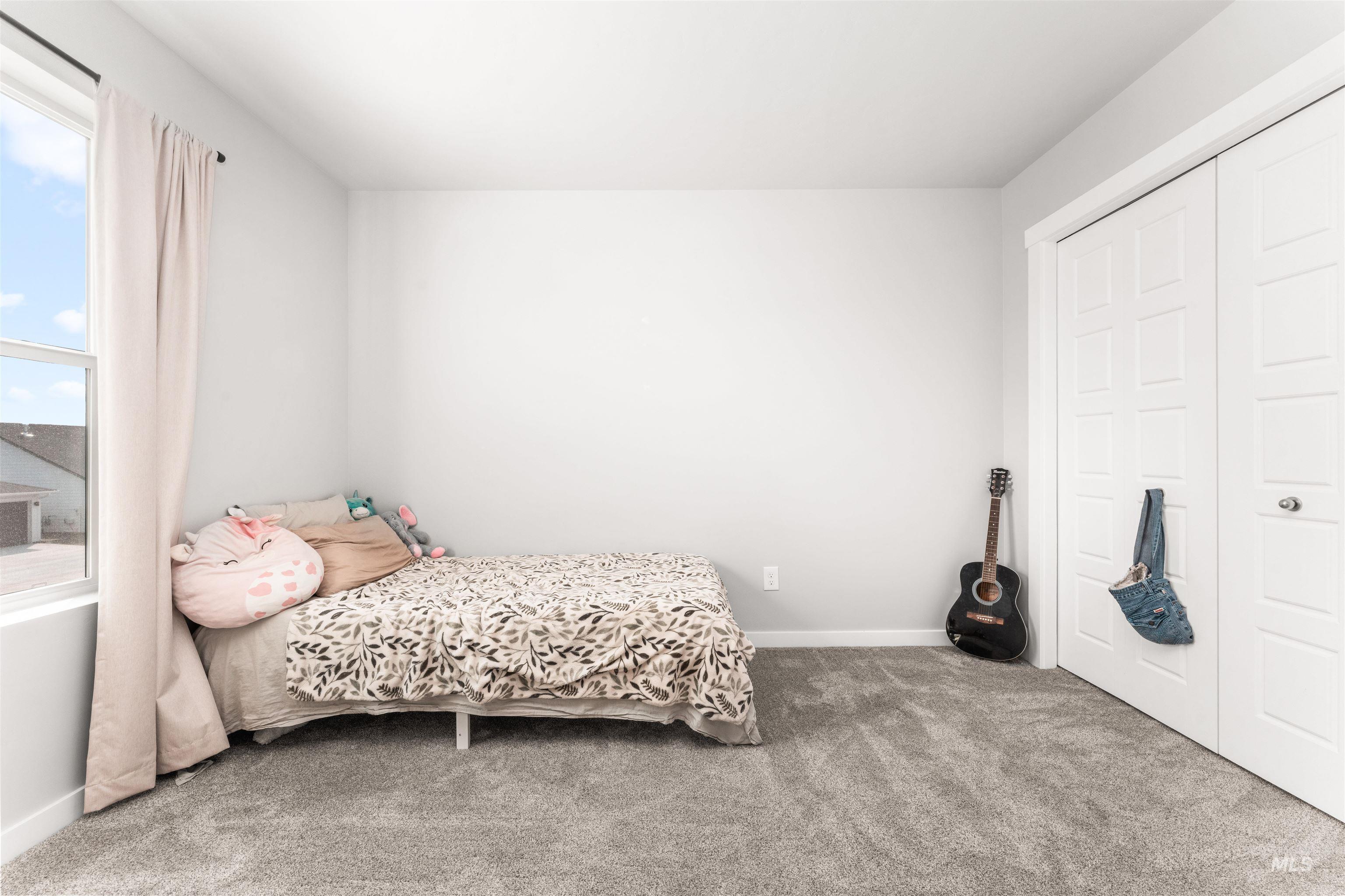 Carpeted bedroom with baseboards