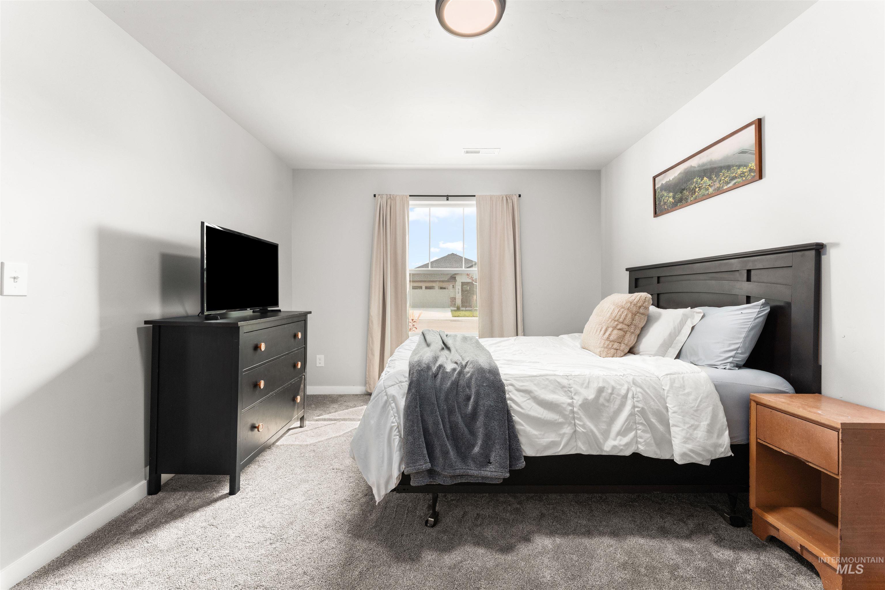 Bedroom with carpet and baseboards