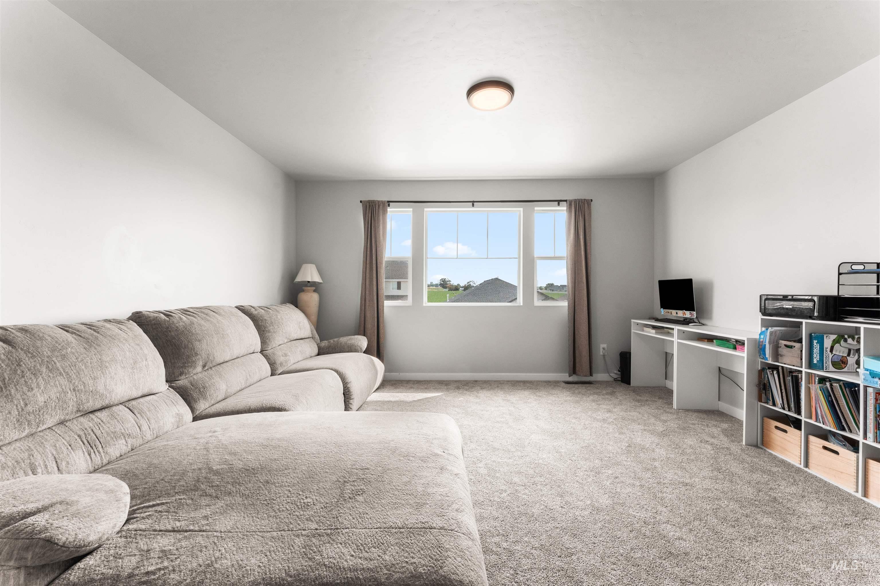 Living room with carpet floors and baseboards
