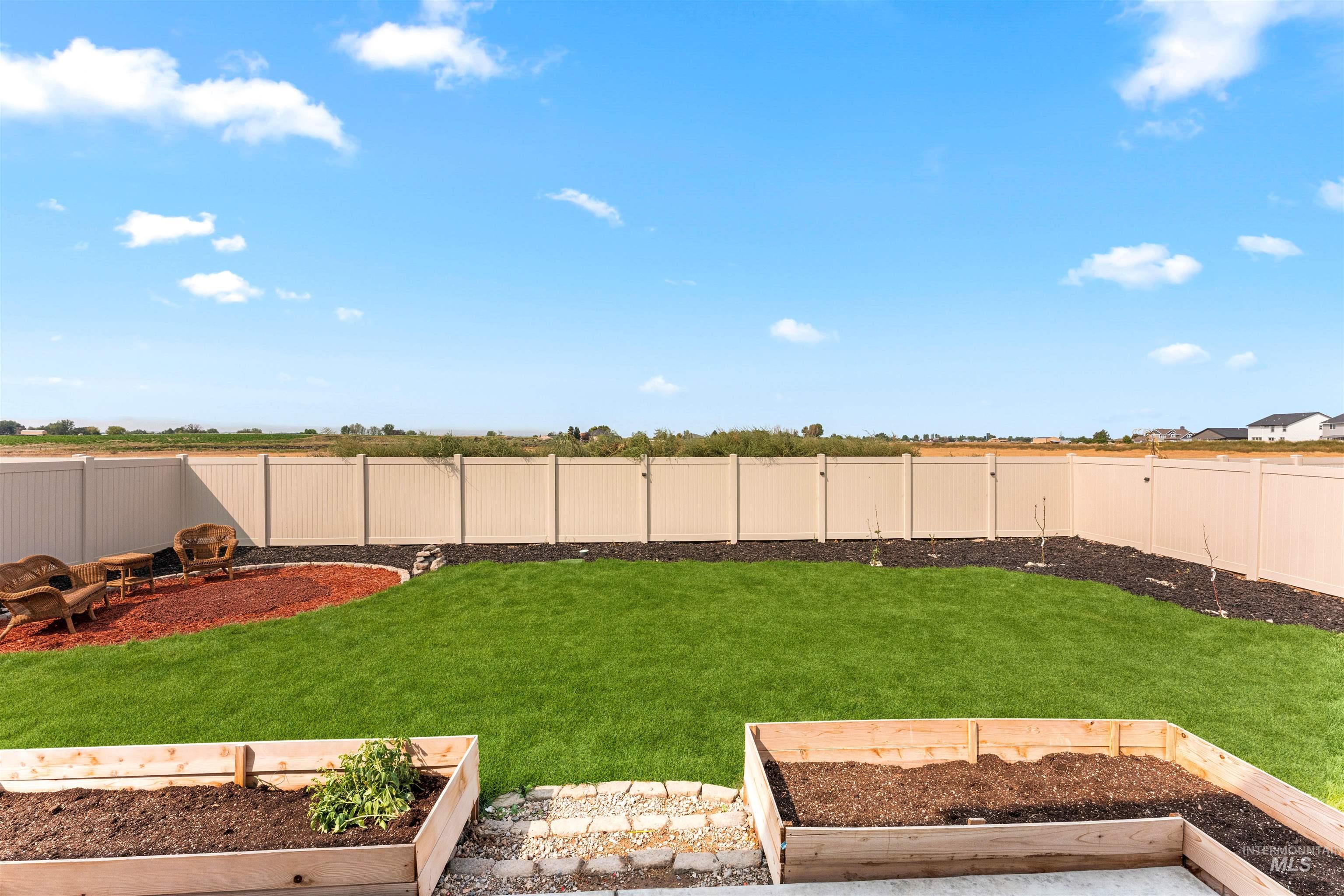 Fenced backyard with a garden and a patio